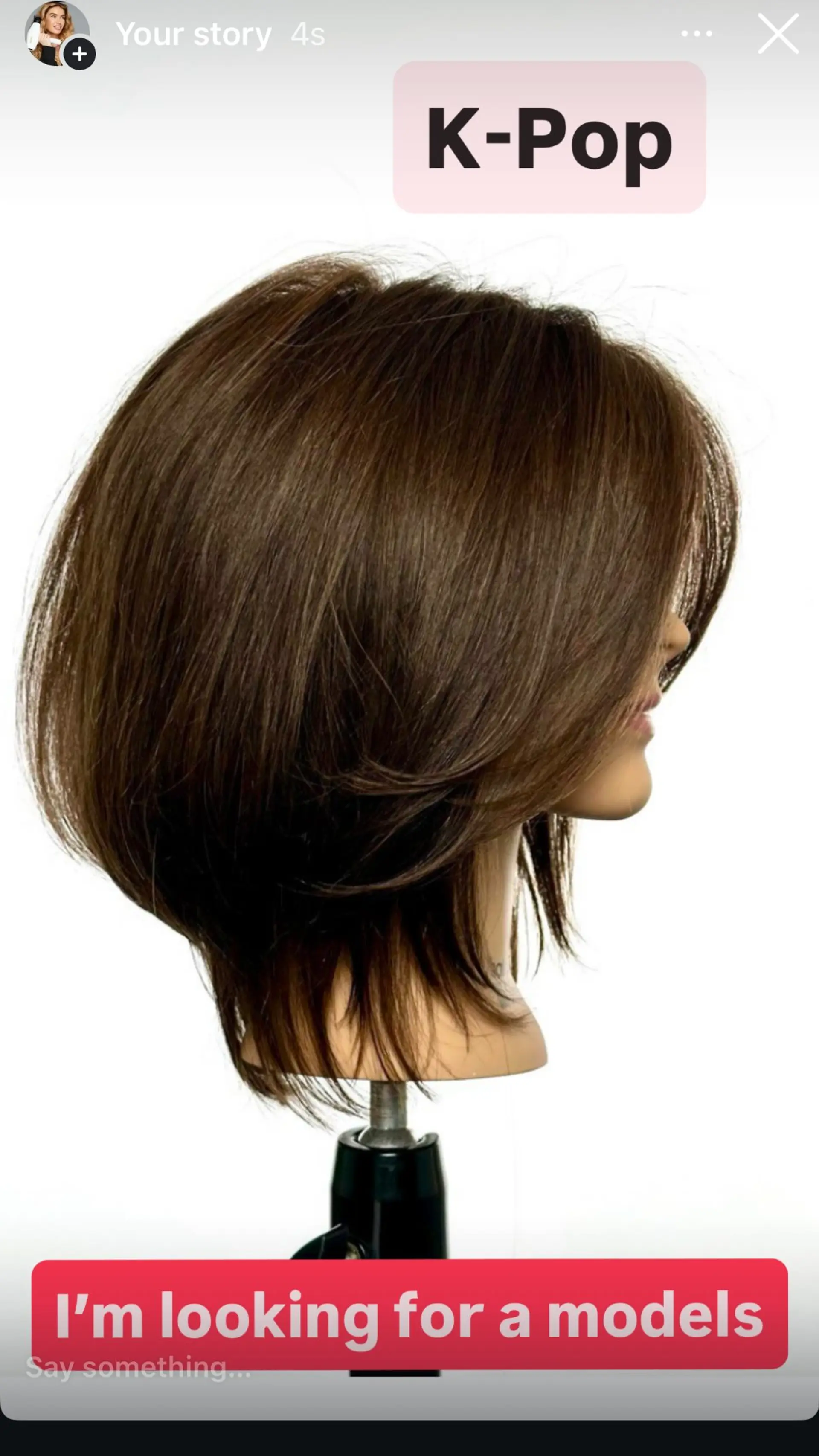 A textured K-pop style layered bob featuring rounded crown volume, soft face-framing layers, and tapered feathered ends. 1