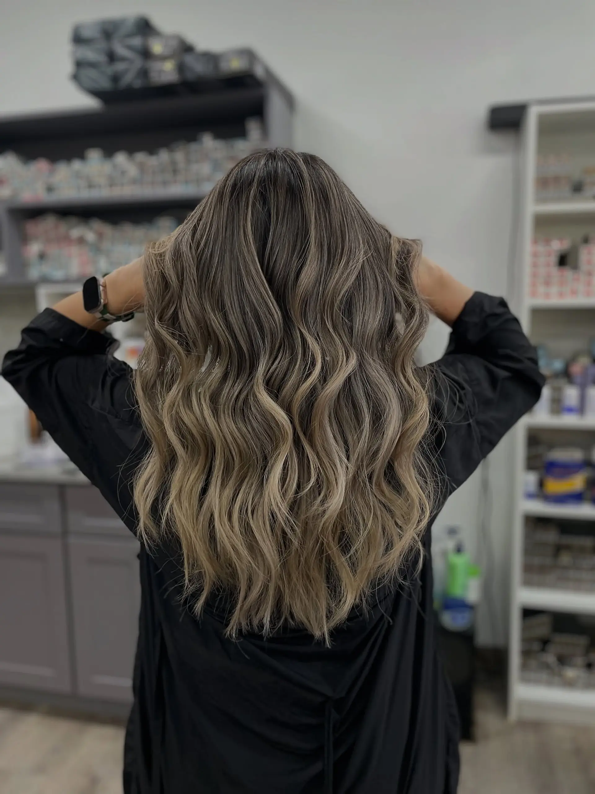 Long layered waves achieved with balayage coloring to create a natural and dimensional look. 1