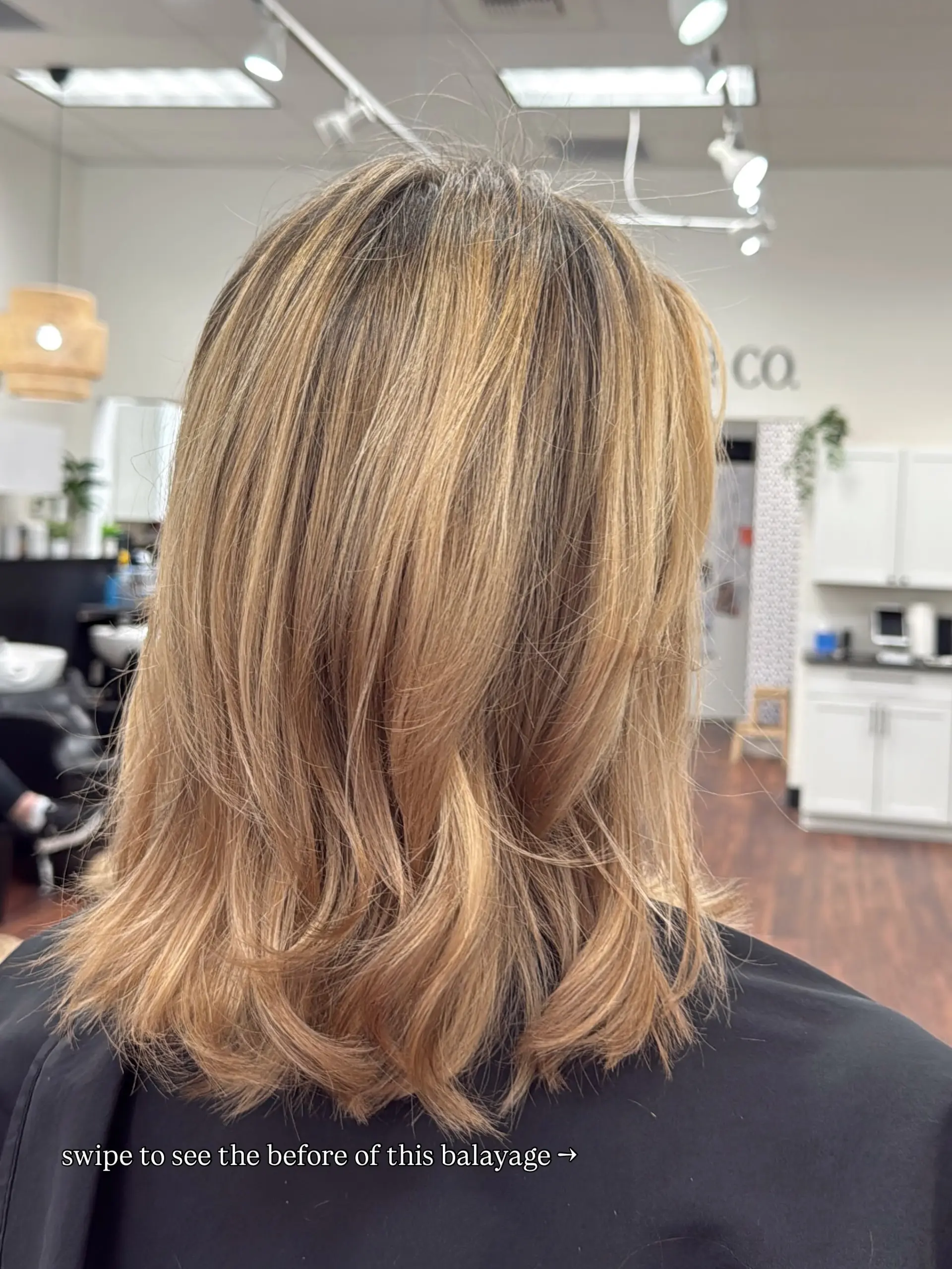 A textured shoulder-length lob featuring a warm honey blonde balayage with soft dimension and flicked-out ends. 1