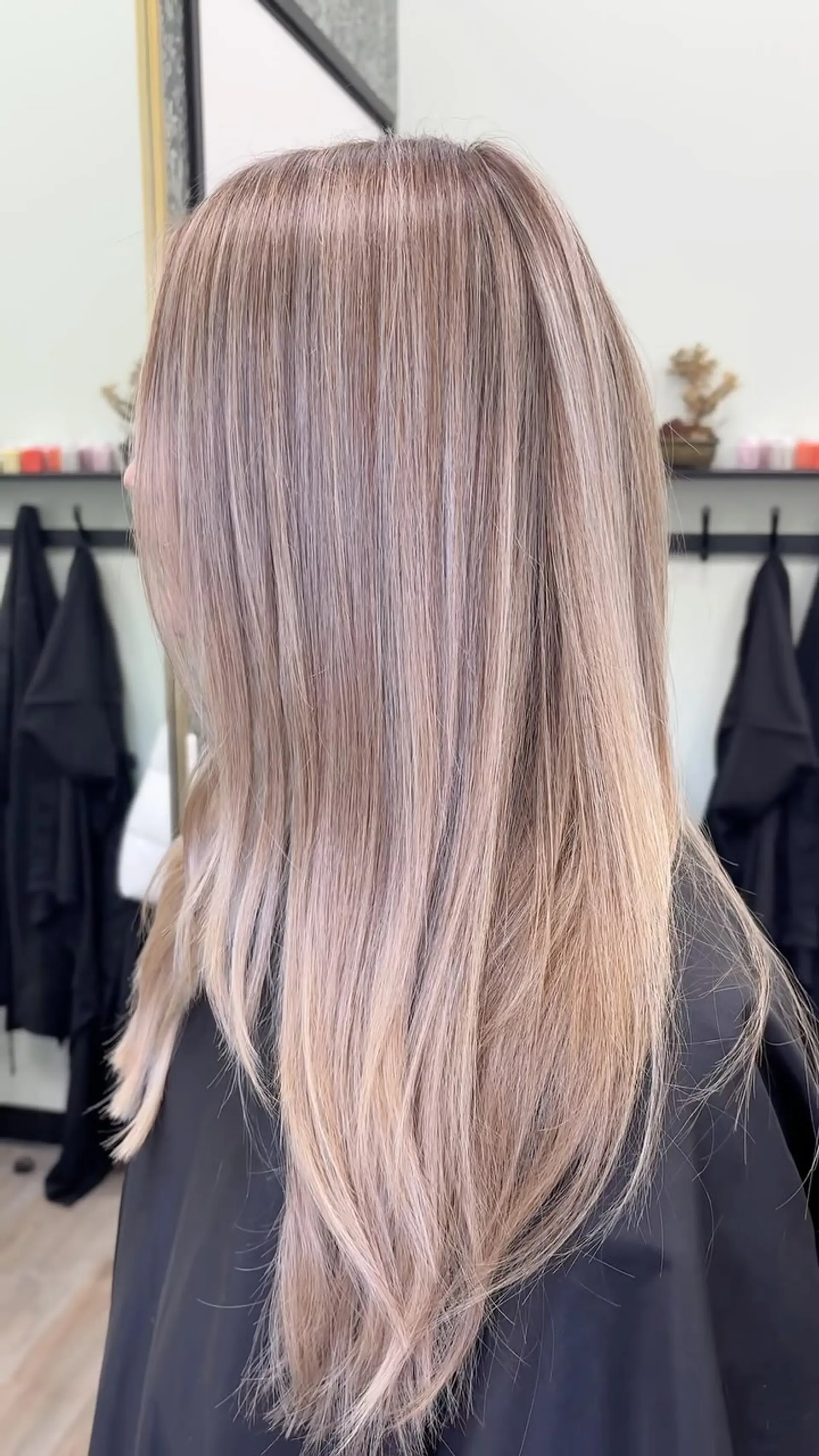Straight, long hair featuring cool ash blonde highlights blended seamlessly from root to end. 1