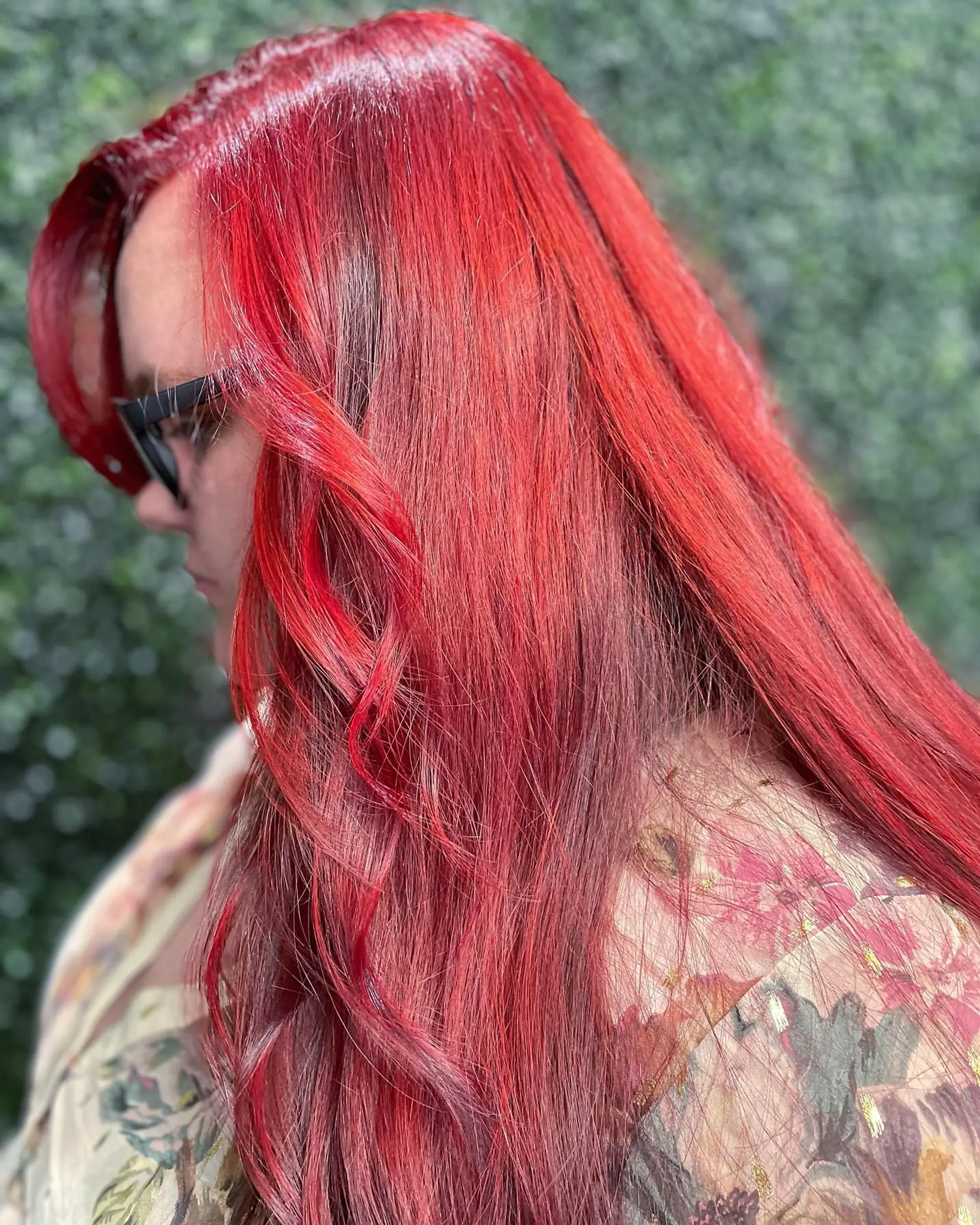 Long hair colored in a rich, vibrant red velvet hue with a high-shine glossy finish. 1