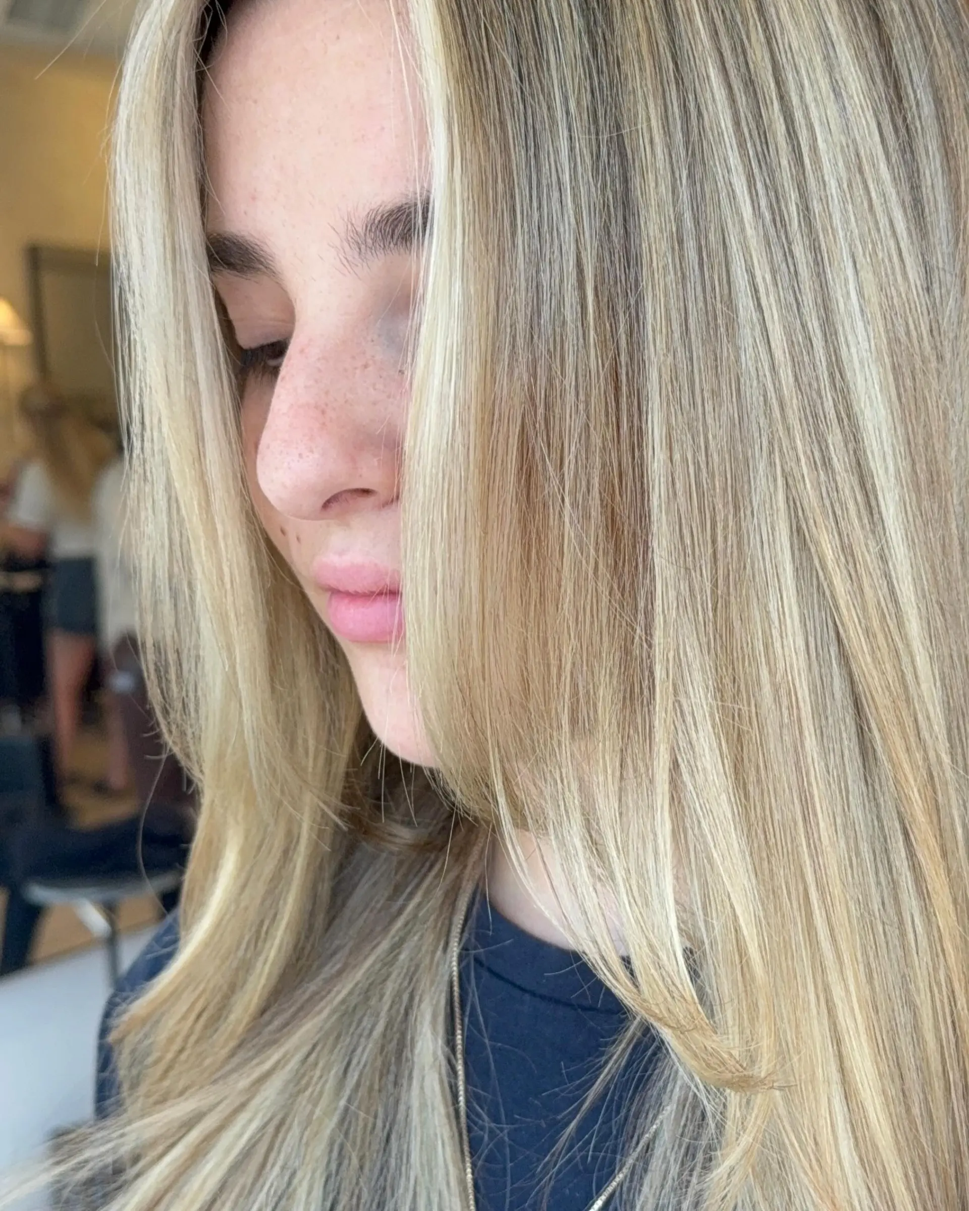 Long, straight butter blonde hair featuring dimensional highlights and a bright face-framing section. 1