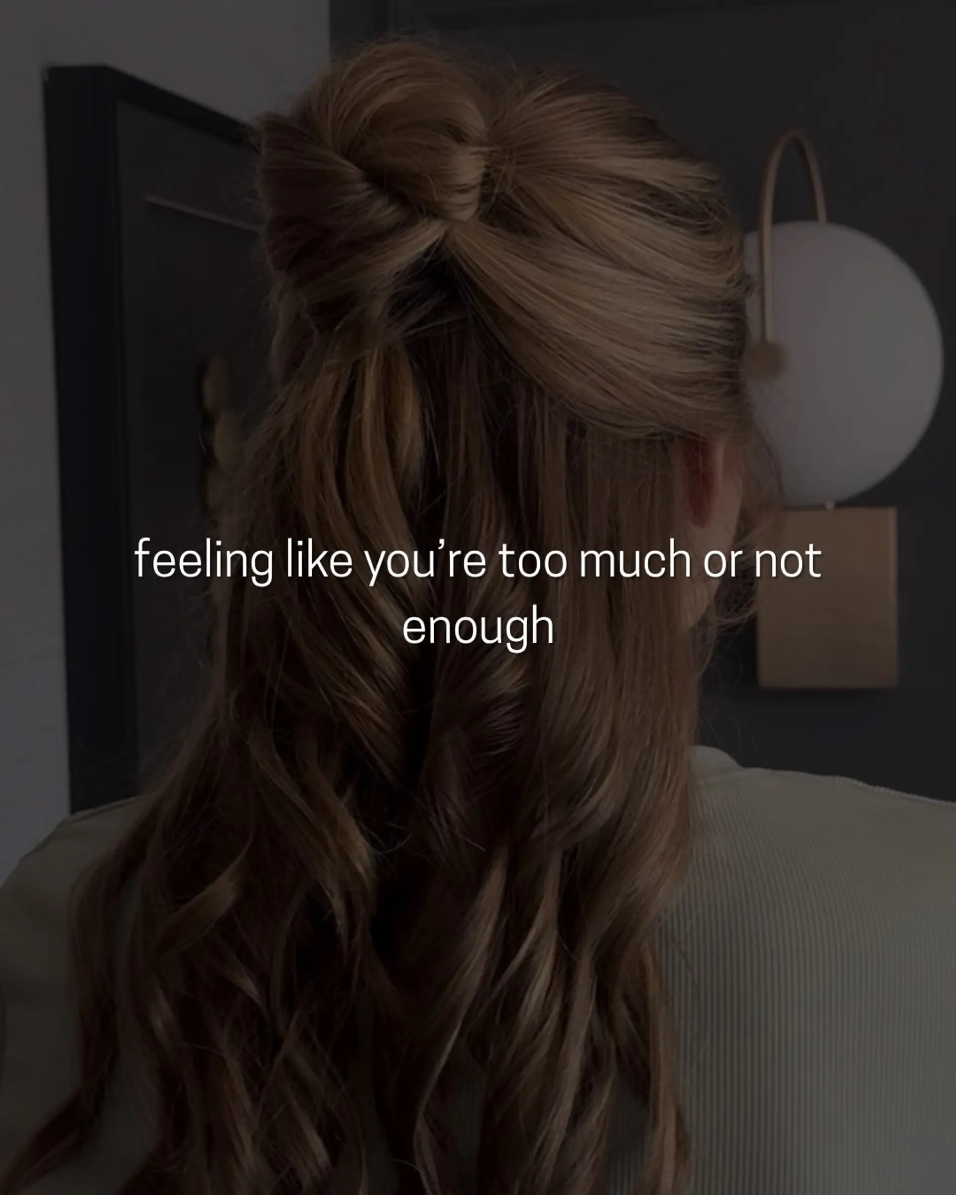 A romantic half-up hairstyle featuring a textured top knot bun paired with long, flowing soft waves. 1