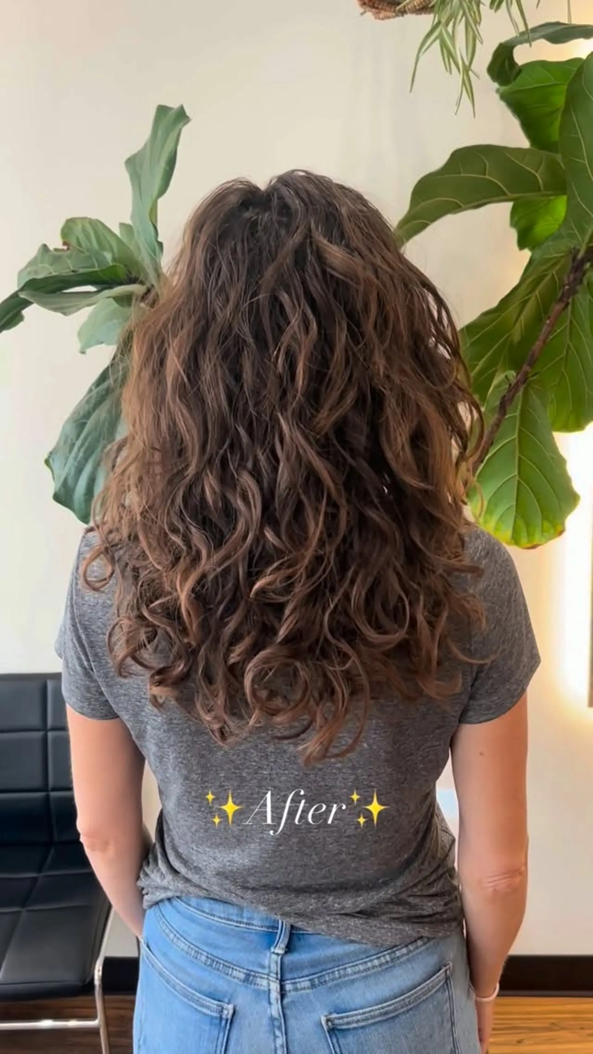 Long brown hair styled in defined, voluminous curls and waves with layered shaping. 1