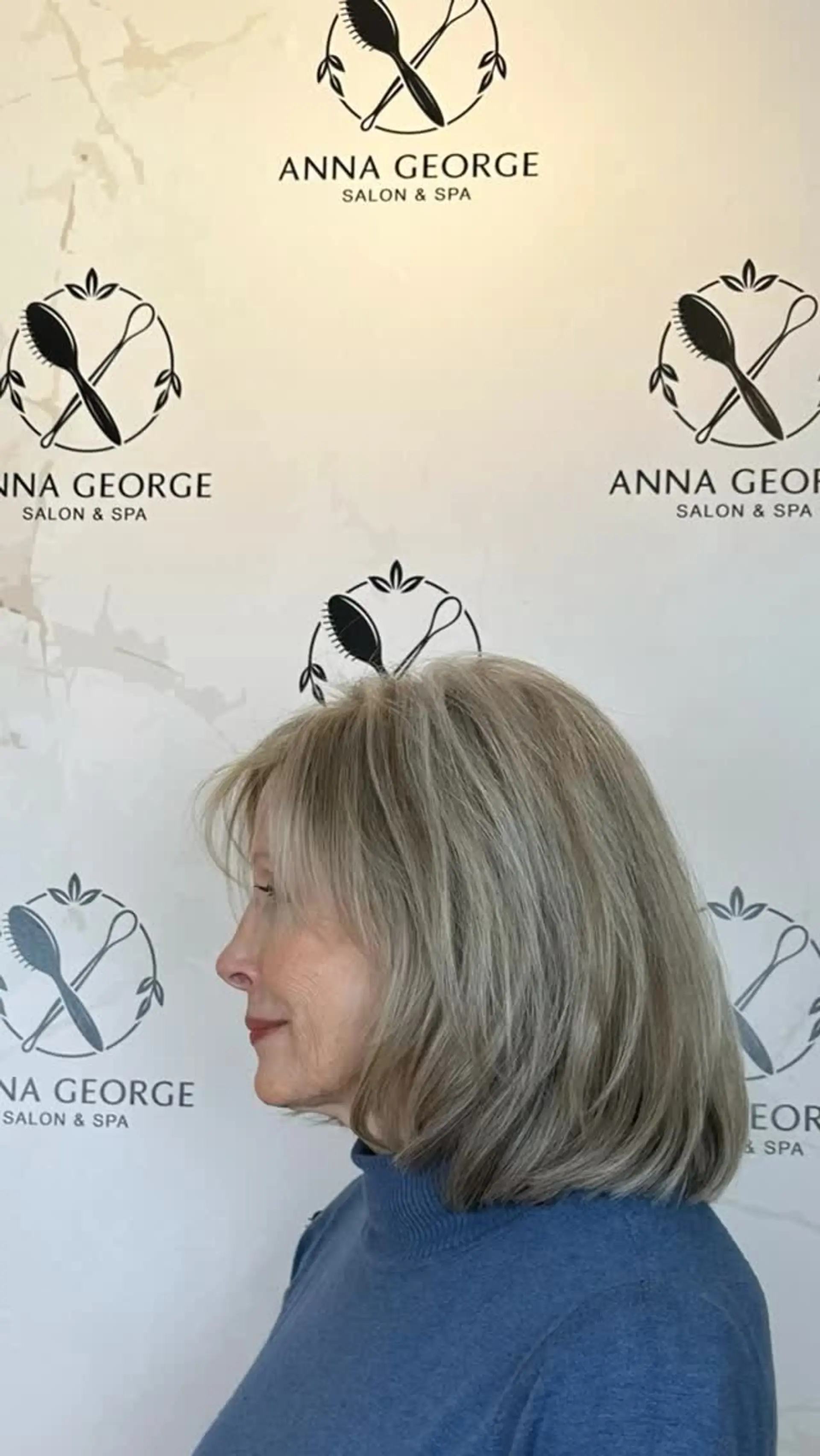 A shoulder-length layered lob with soft wispy bangs, featuring cool-toned dimensional highlights and lowlights for gray blending. 1