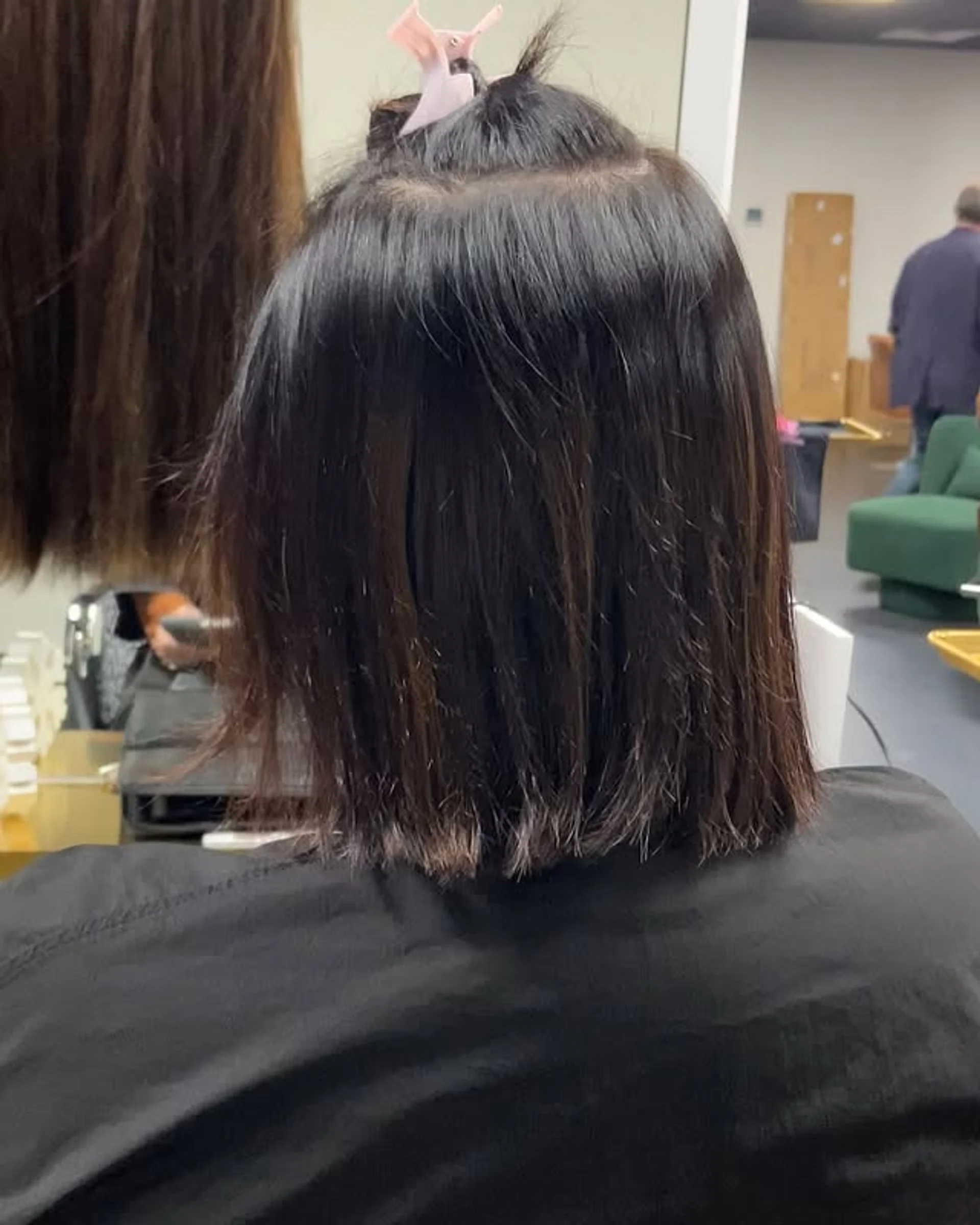 Woman sporting a sleek, blunt edgy bob haircut - Preview 2