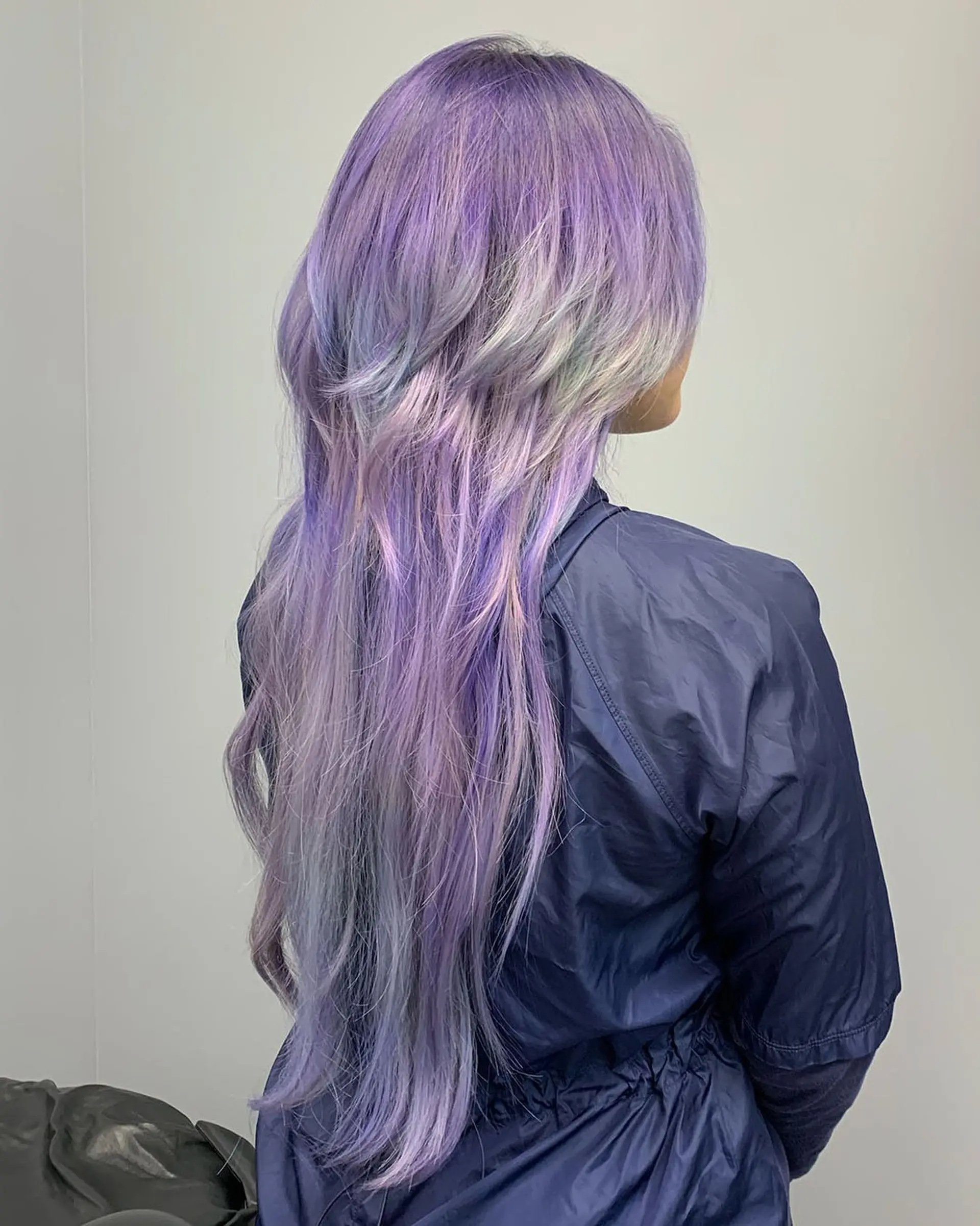 A dramatic jellyfish haircut featuring a layered bob-style upper section and extra-long straight under-layers colored in pastel lavender and silver tones. 1
