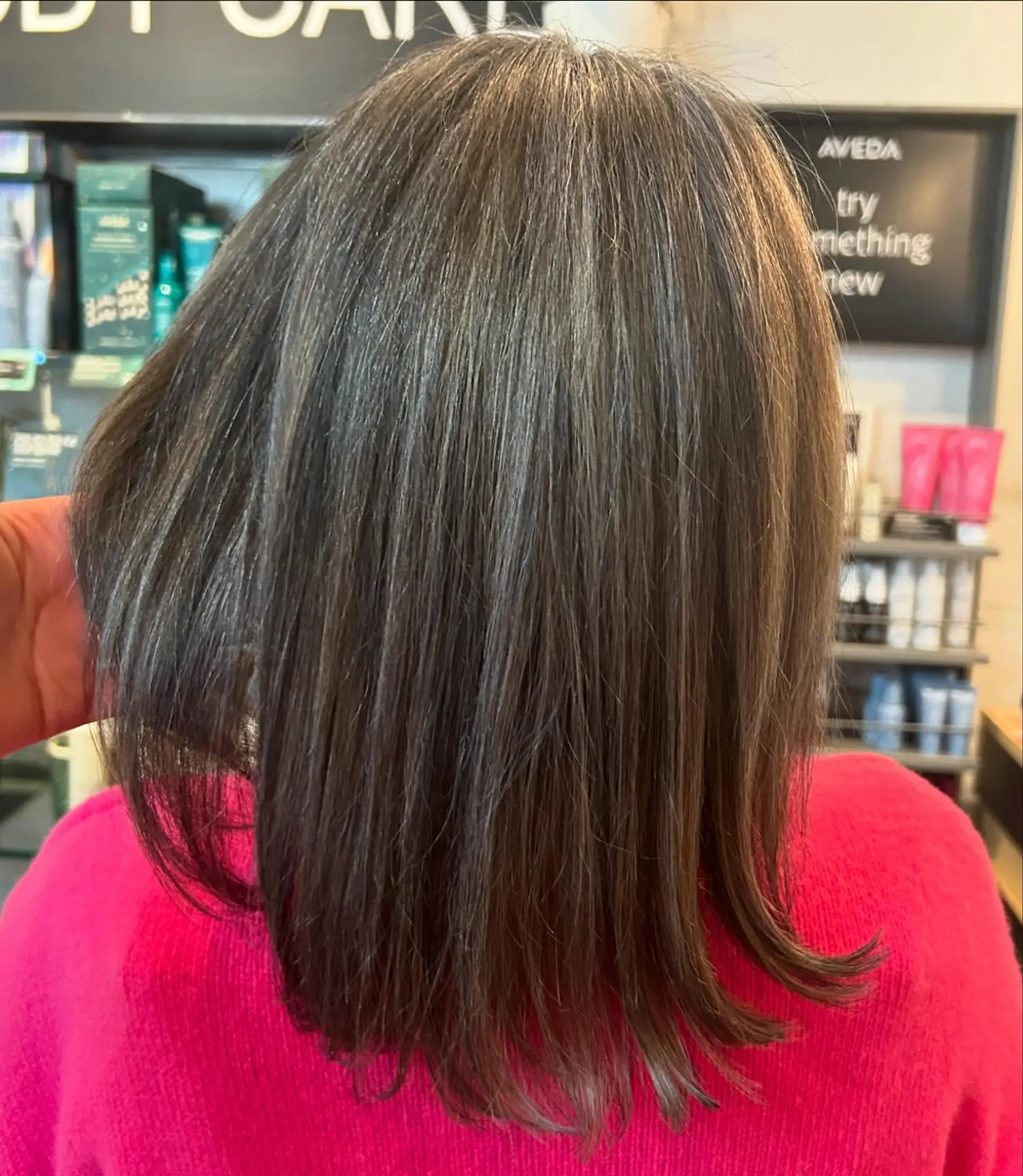 A straight shoulder-length brunette cut styled smooth with lightly textured, subtly flicked ends. 1