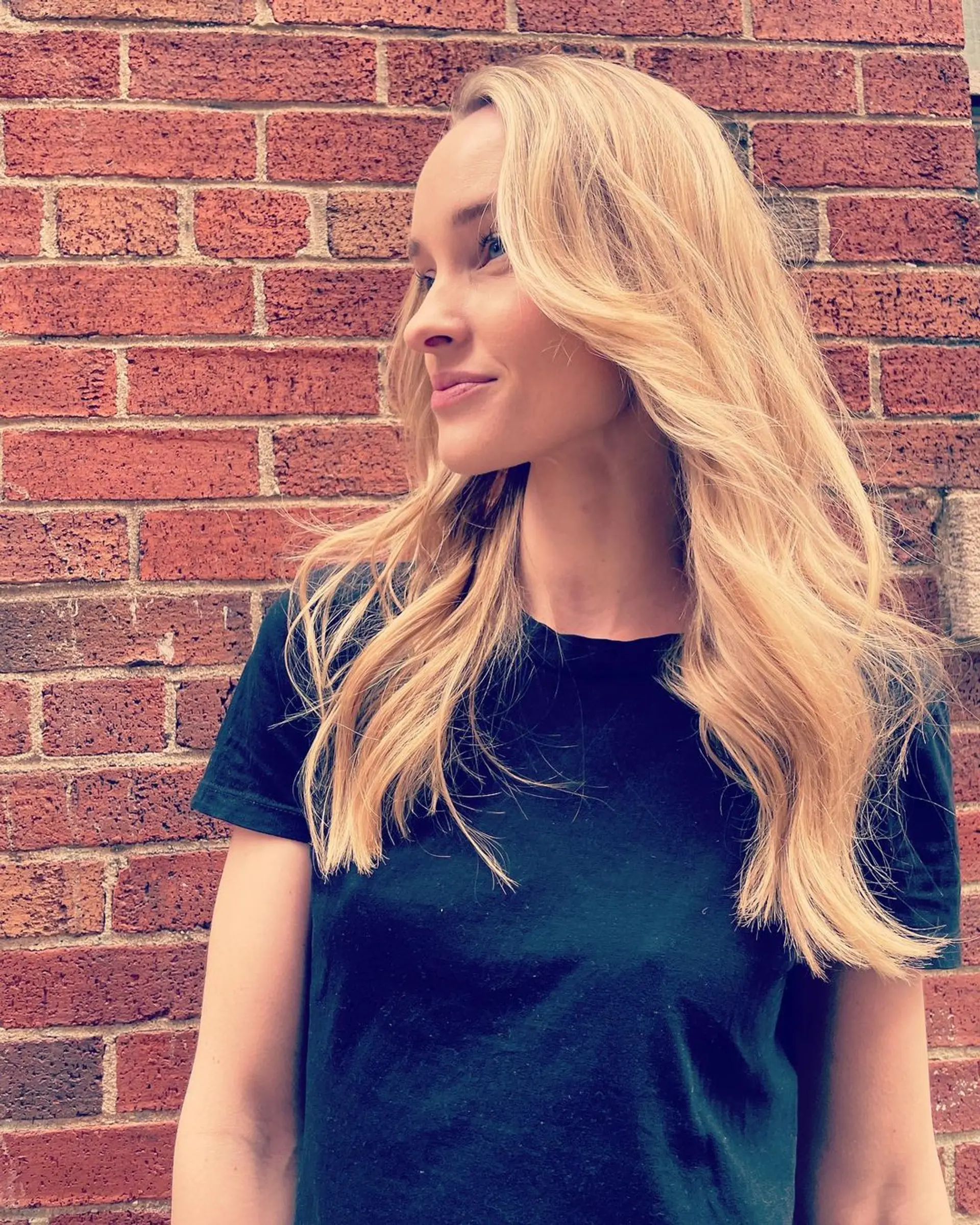 Long, wavy blonde hair with layers and a natural side part, creating an effortless and voluminous look. (Hair by Lynn) 1