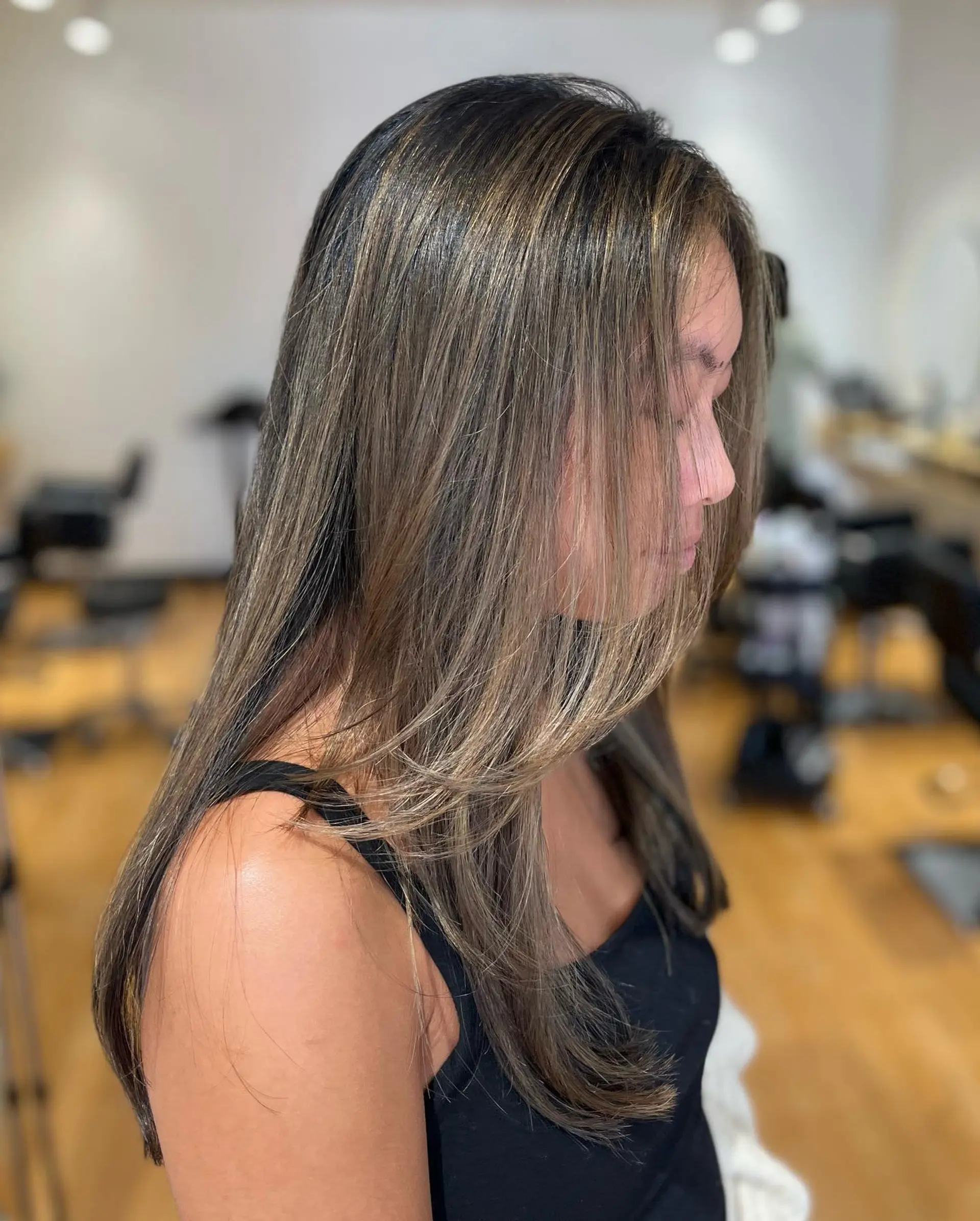 Long straight hair cut with smooth, face-framing layers and soft ash-toned balayage highlights over a dark brunette base. 1