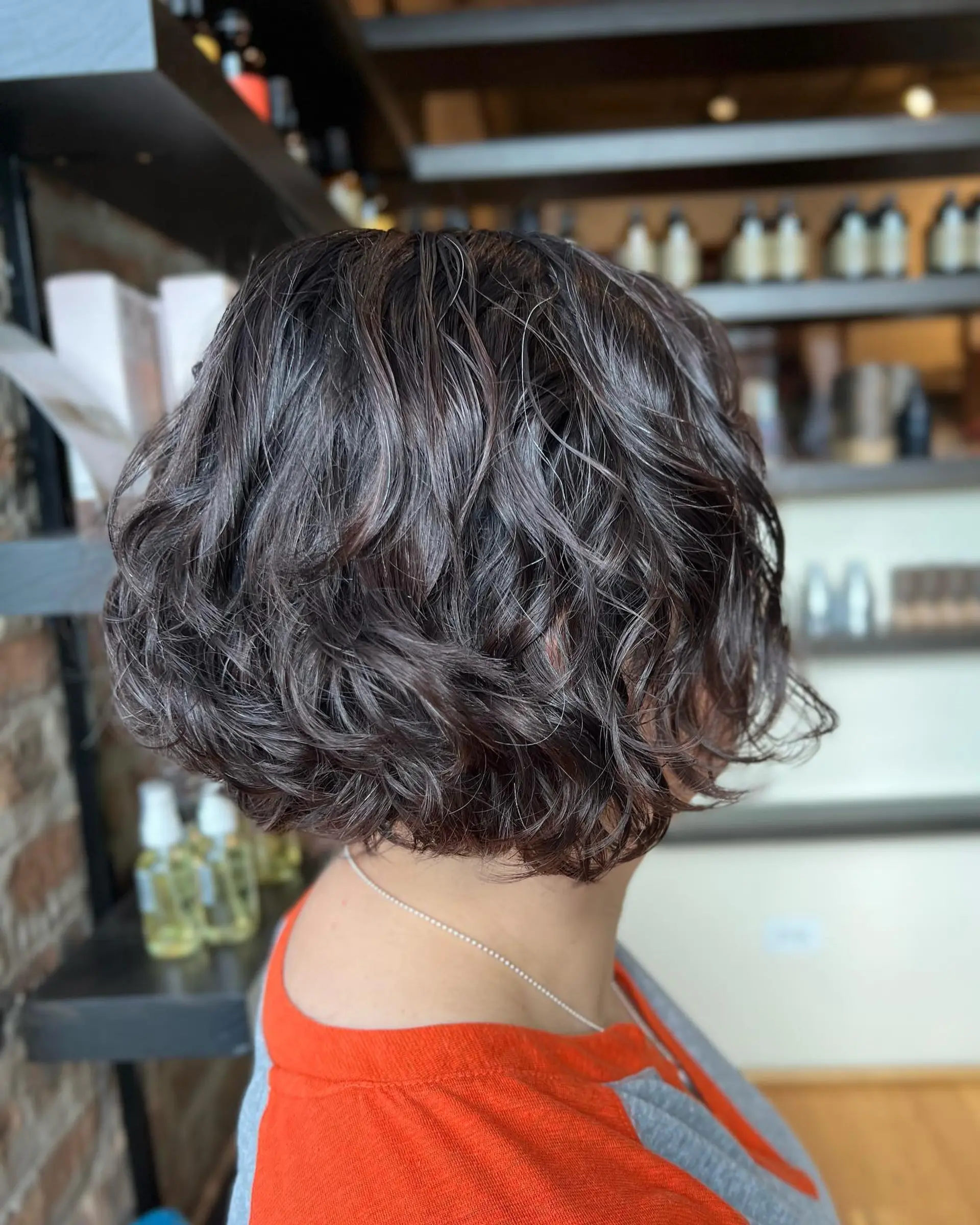 A short, curly bob with lots of texture and volume. 1