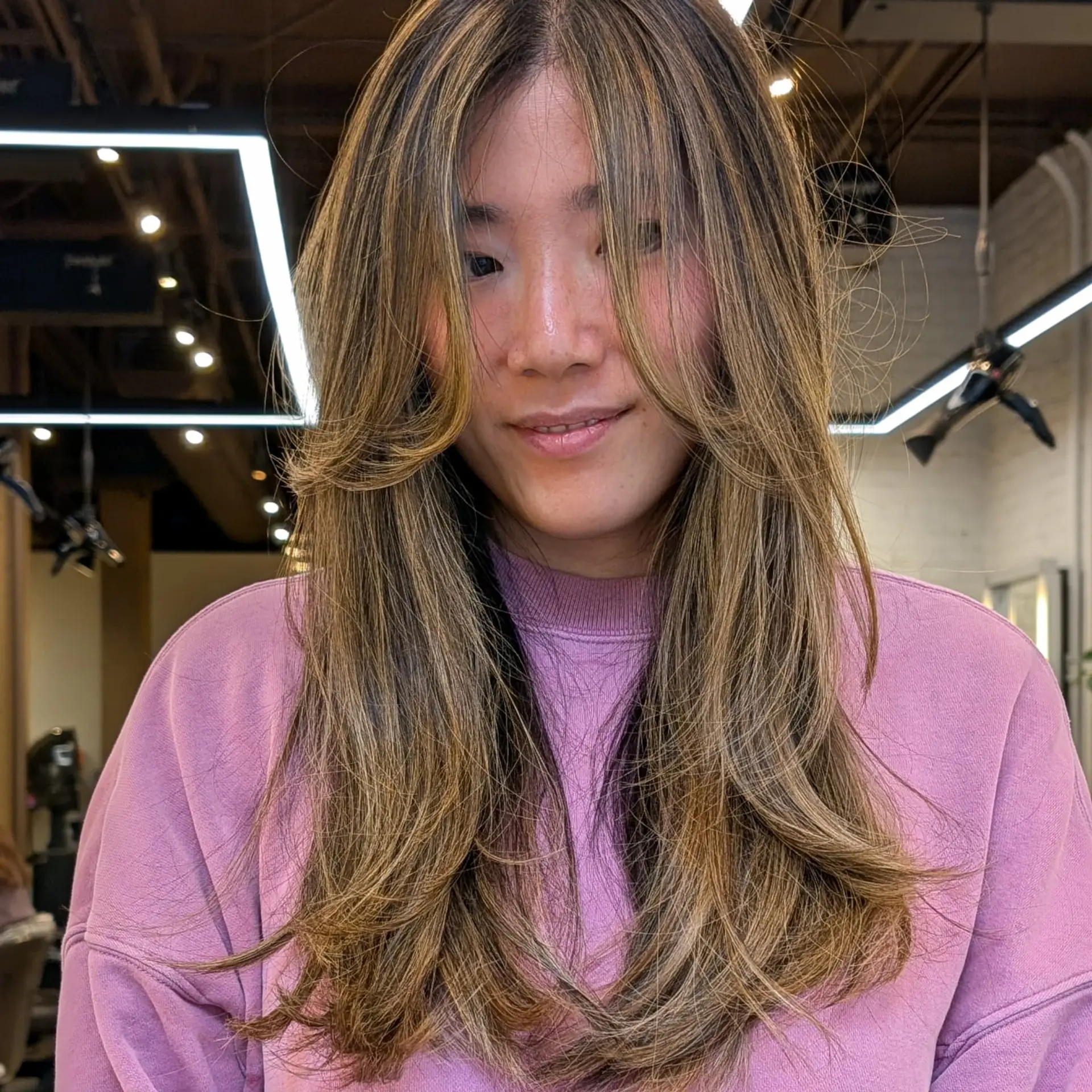 Long layered haircut with face-framing layers that accentuates the face. 1