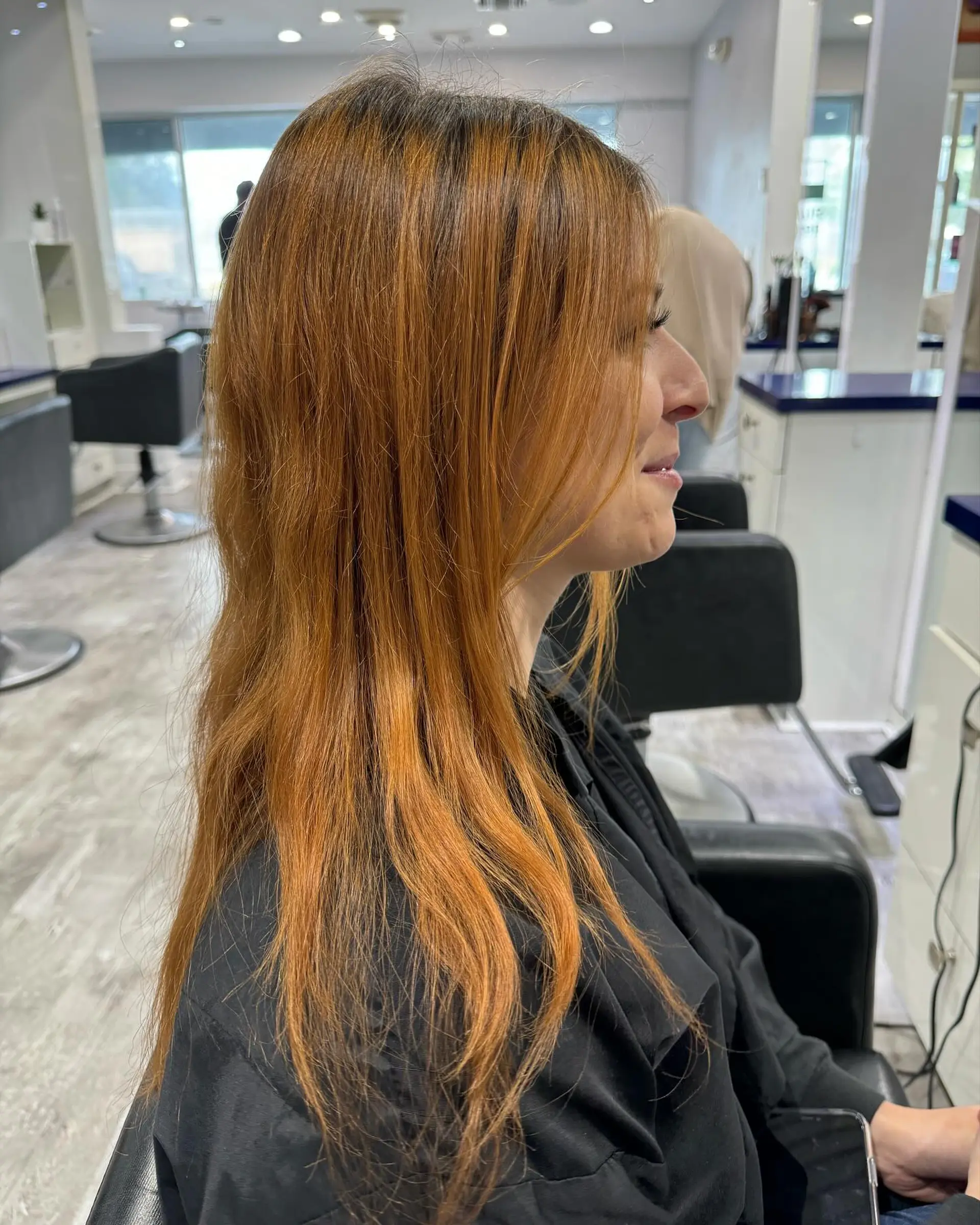 Long, wavy hair with a dark root ombre to blonde beach waves. 4