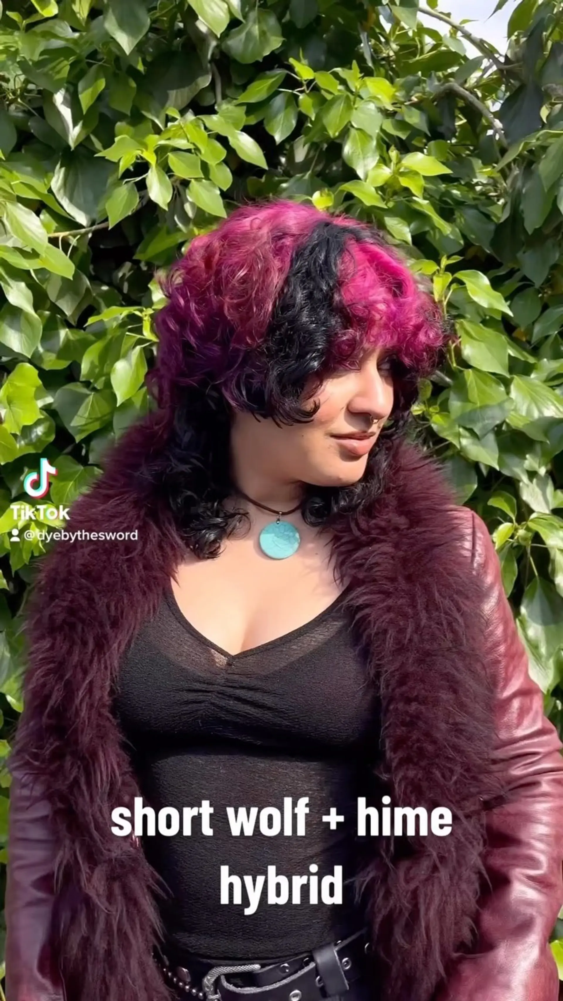 A textured curly wolf cut combined with hime-inspired framing layers and fringe, featuring bold vivid magenta and black color blocking. 1