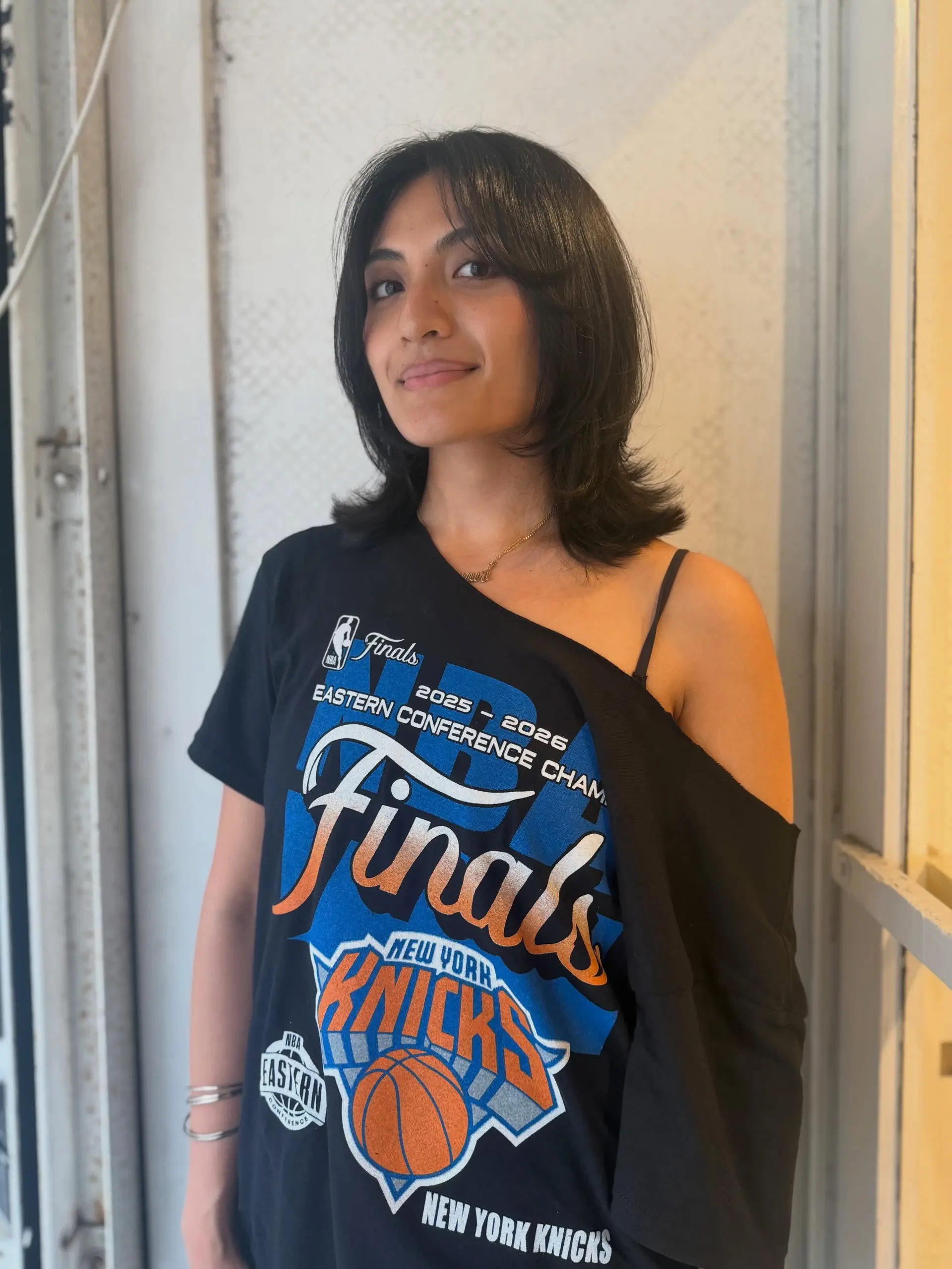 A shoulder-length haircut featuring lived-in layers, face-framing curtain bangs, and subtle flipped ends. 1