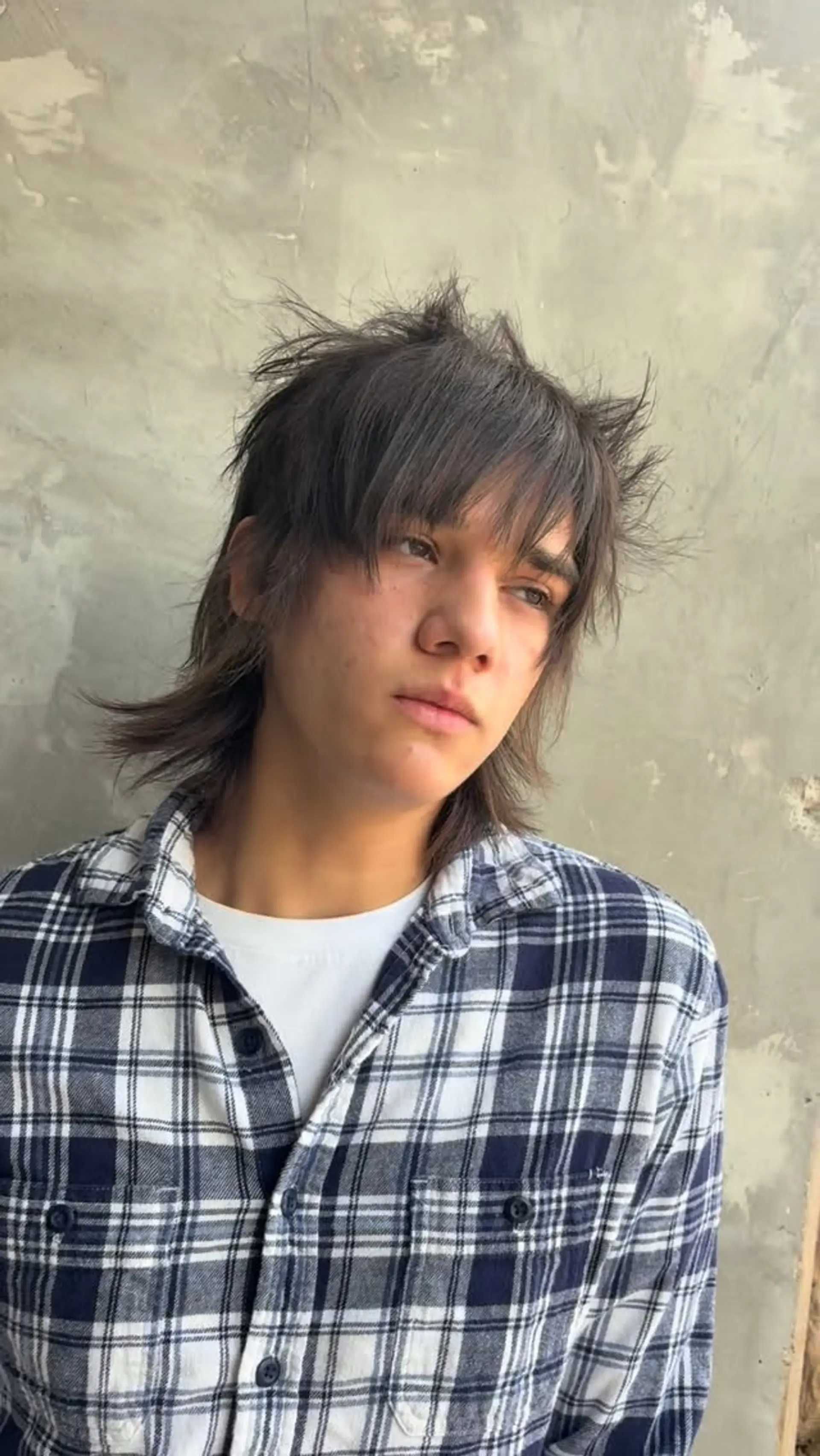 A heavily layered, alternative shag mullet cut with piecey front bangs and textured, flicked-out length at the neck. 1