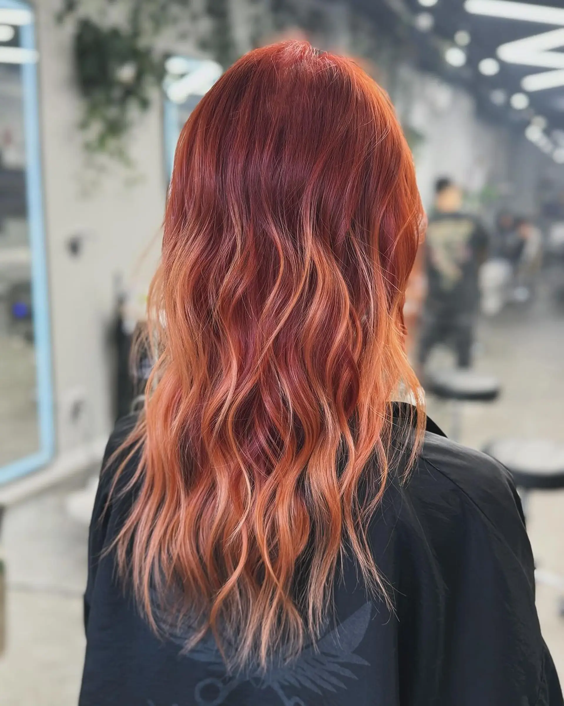 A long, wavy hairstyle featuring an ombre effect with a transition from fiery red to orange and finally to blonde at the tips. Voluminous waves add texture and movement.
Stylist - @xcellent_jason 1