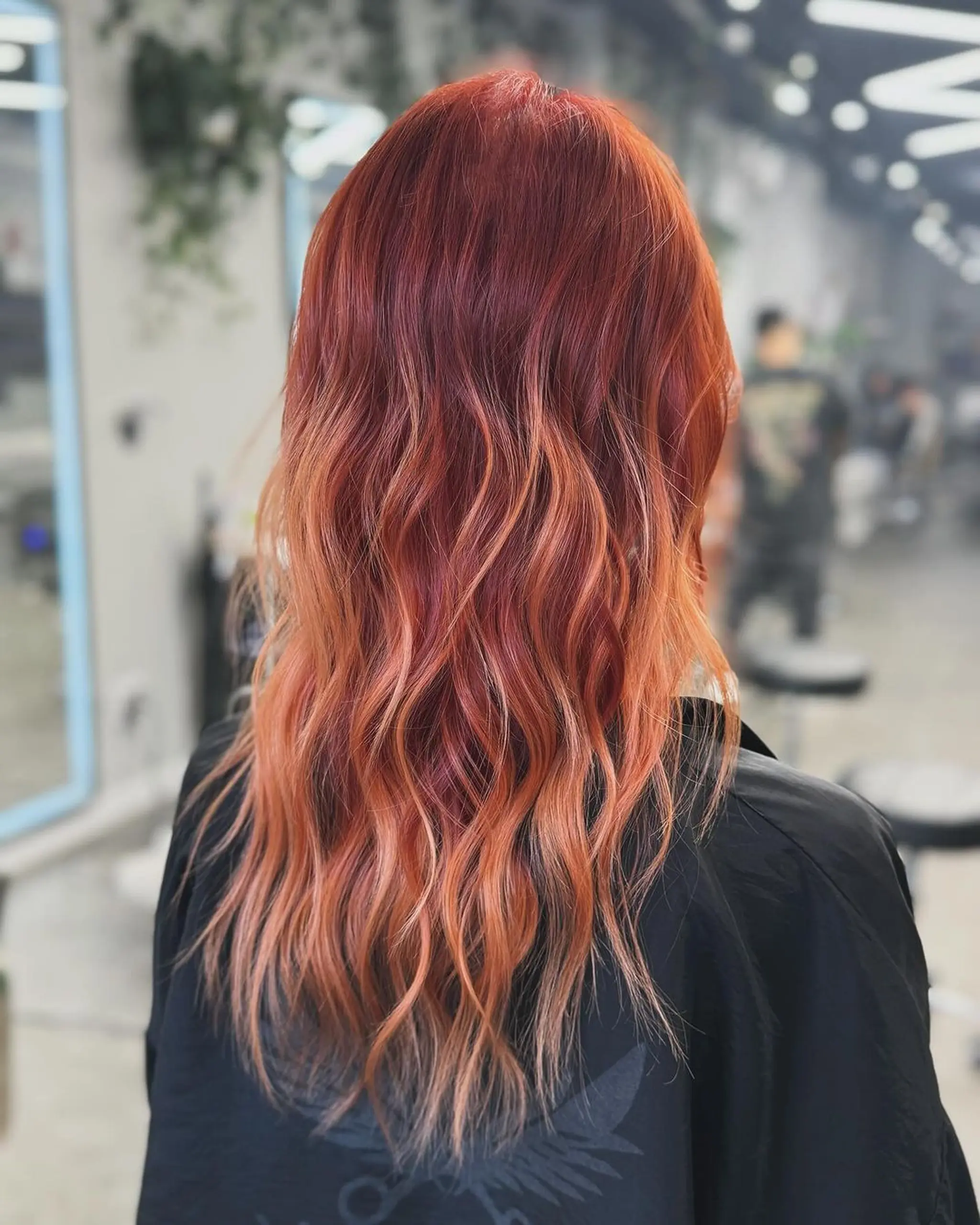 A long, wavy hairstyle featuring an ombre effect with a transition from fiery red to orange and finally to blonde at the tips. Voluminous waves add texture and movement.
Stylist - @xcellent_jason