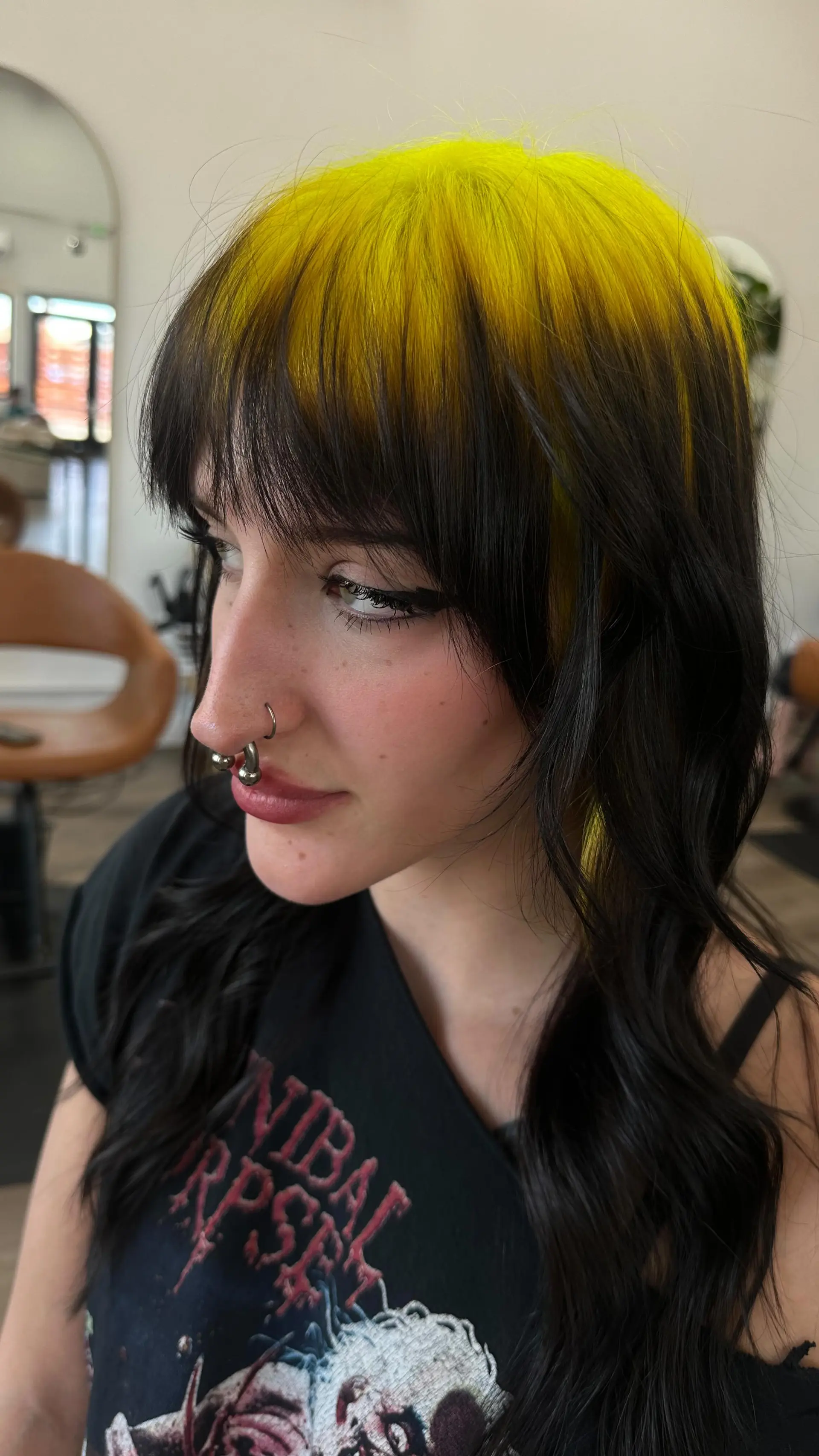 A bold two-tone style featuring vivid neon yellow at the crown contrasted against soft black waves and a straight-across fringe. 1