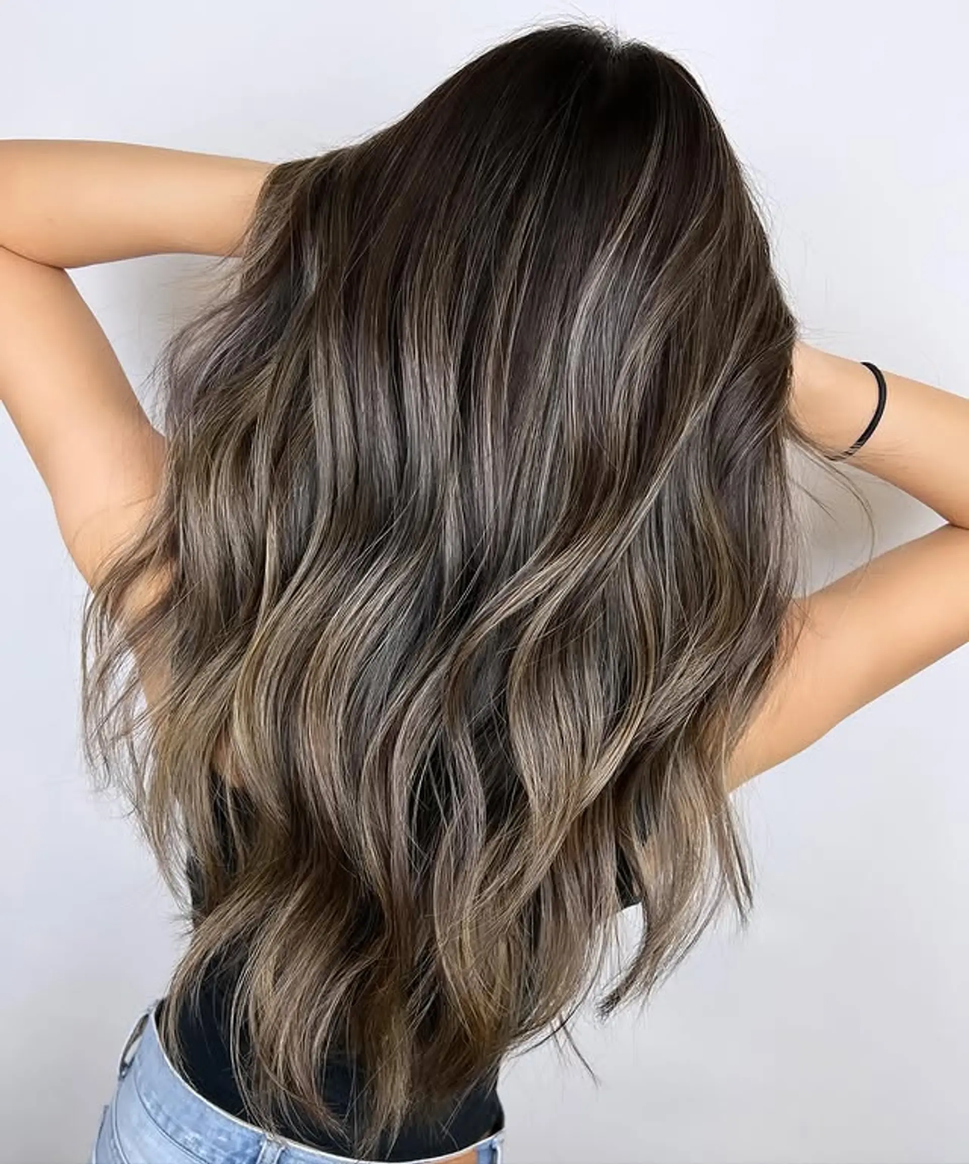 Long, wavy hair with a dark base and ash blonde balayage highlights. 1