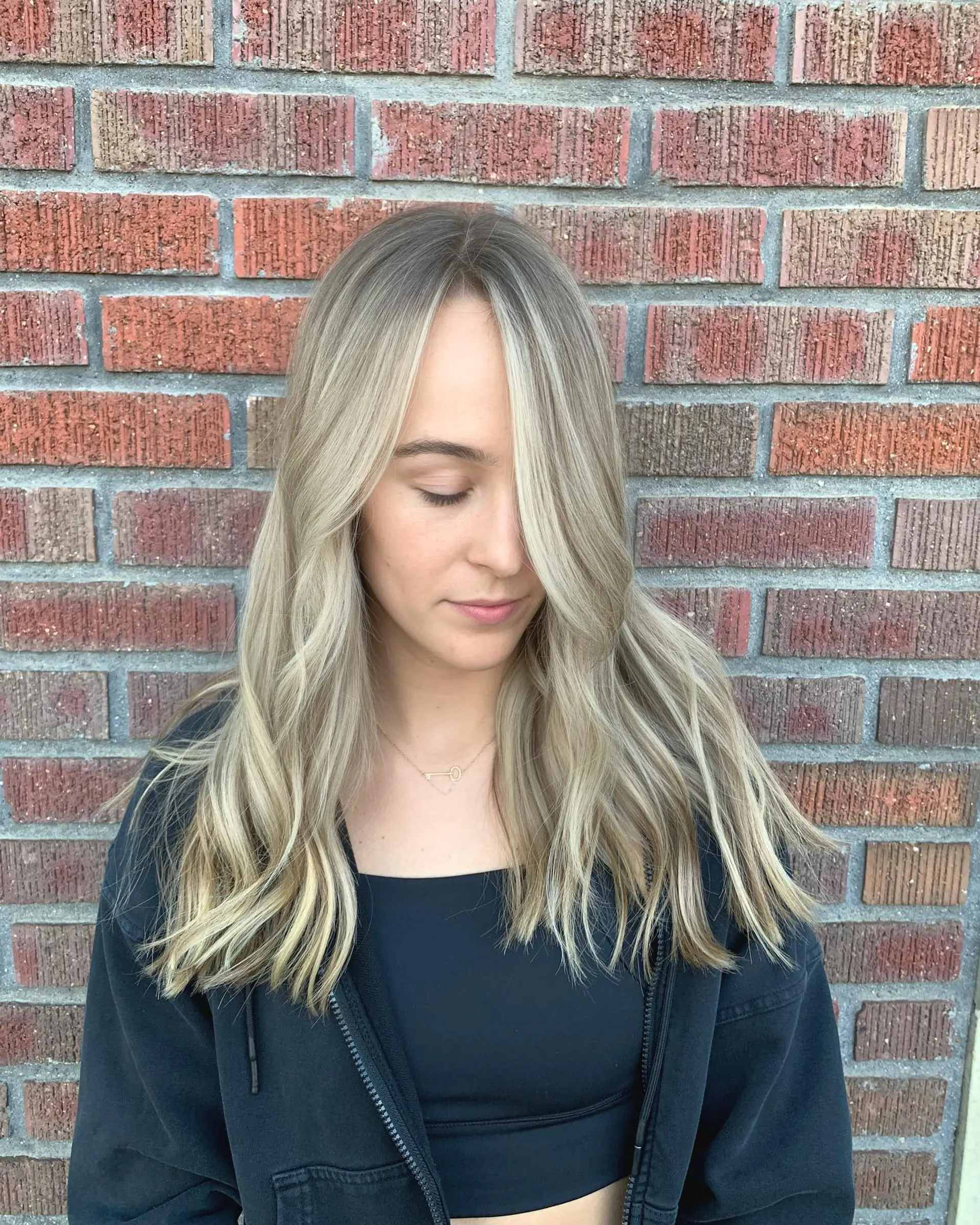 Long ash blonde hair with seamless face-framing highlights and soft waves. 1
