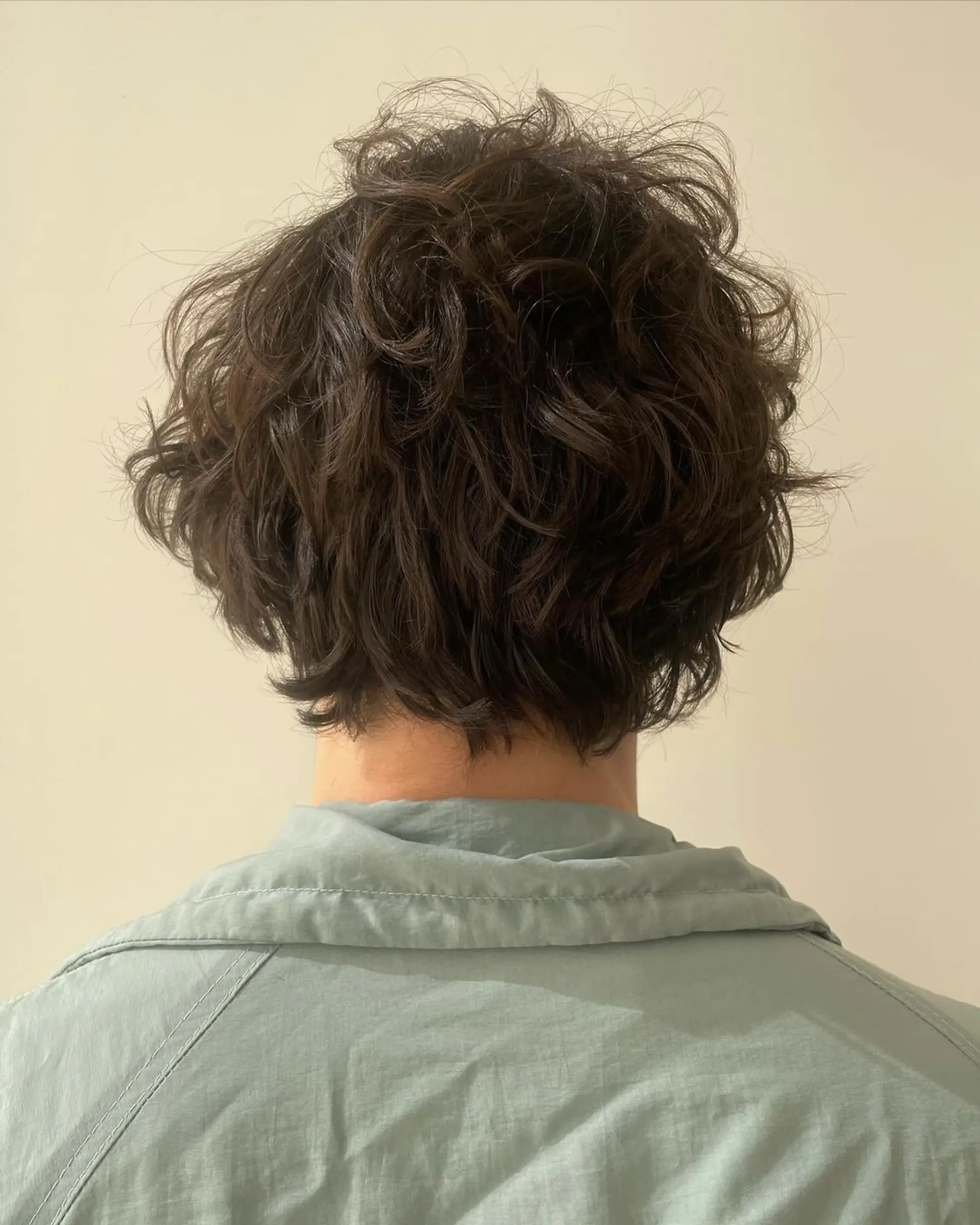 Medium-length wavy dark brown hair with side-swept layers, a natural flow, and tousled texture. 2