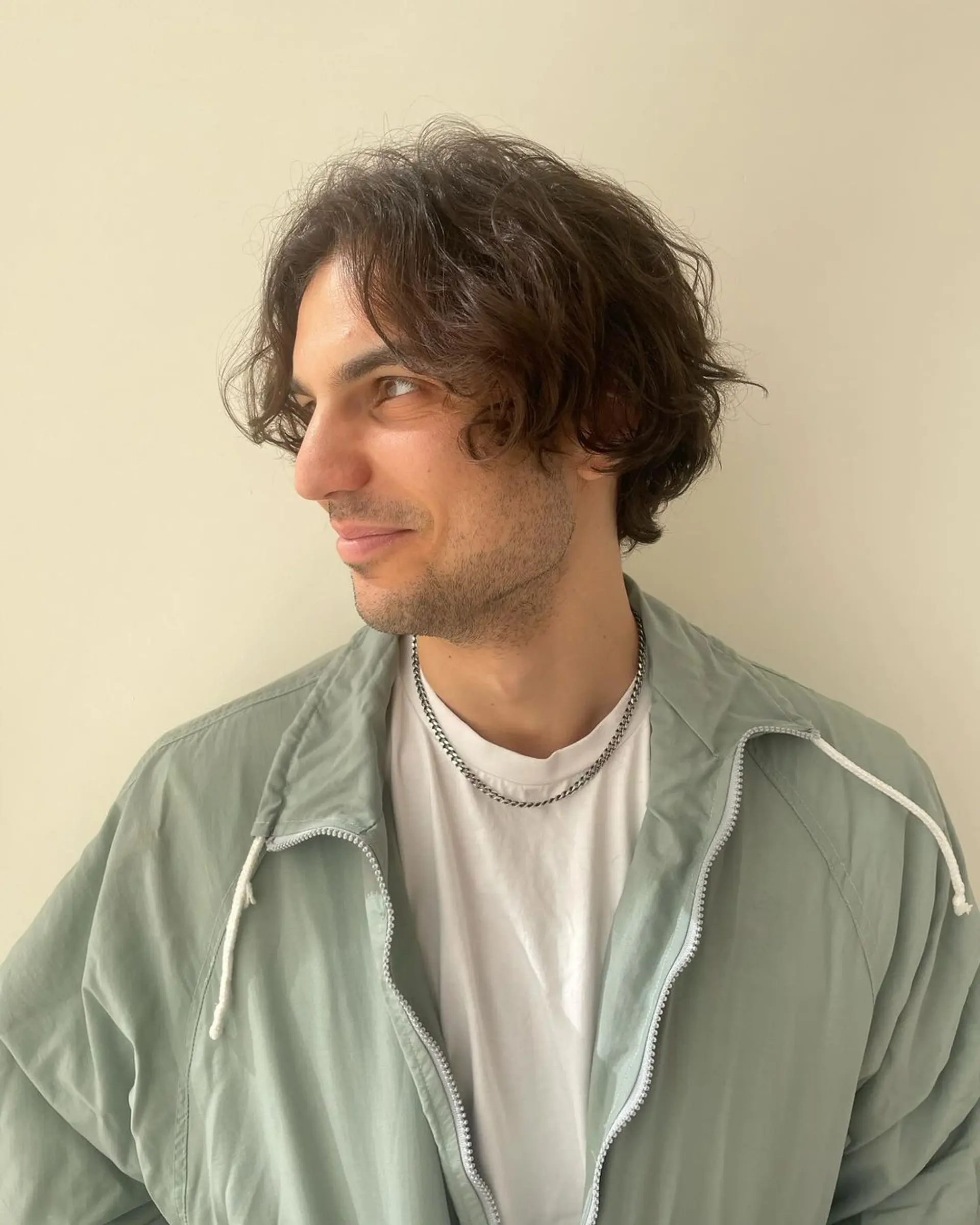 Medium-length wavy dark brown hair with side-swept layers, a natural flow, and tousled texture. 1