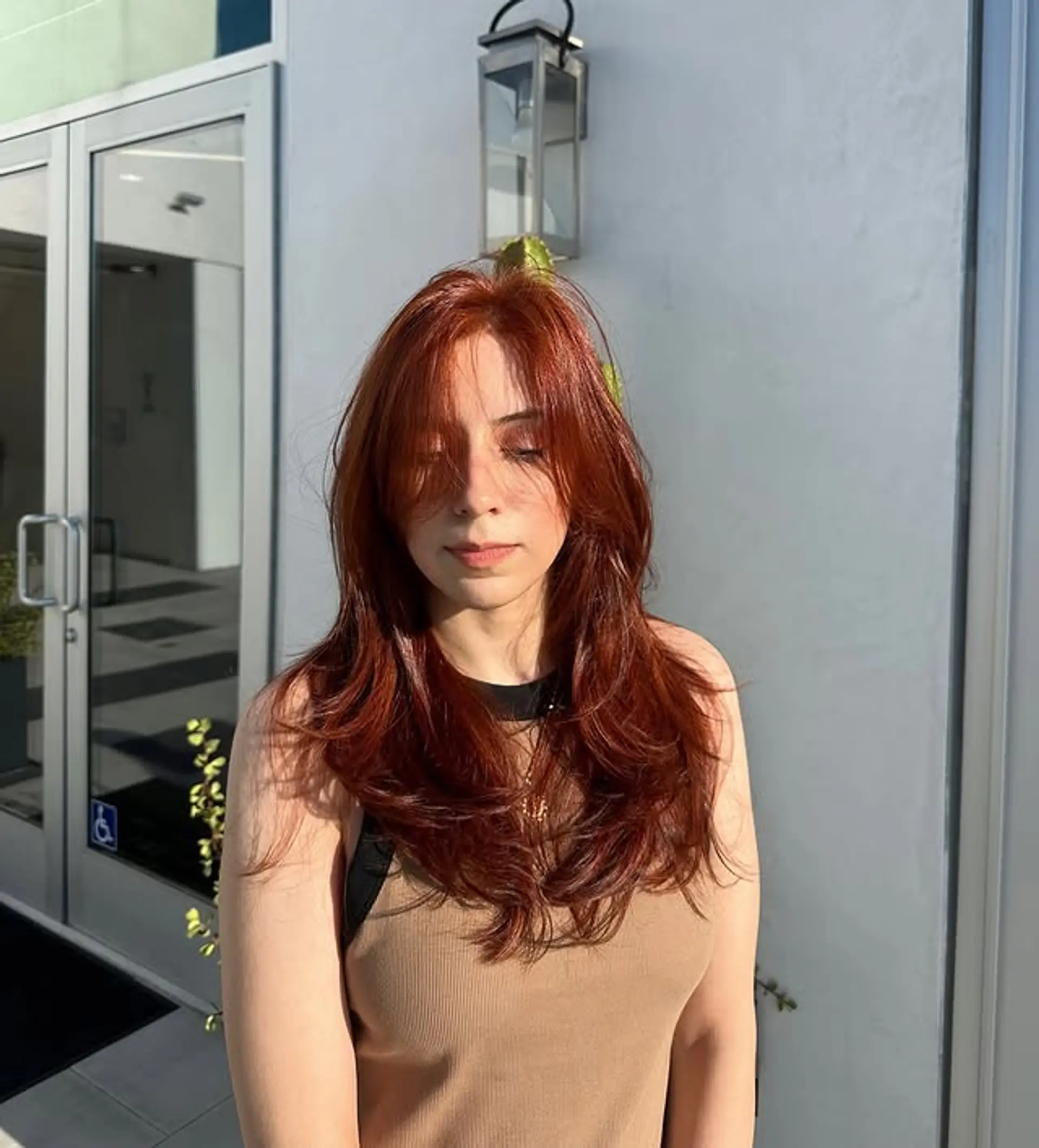 A layered medium length haircut with soft waves. 1