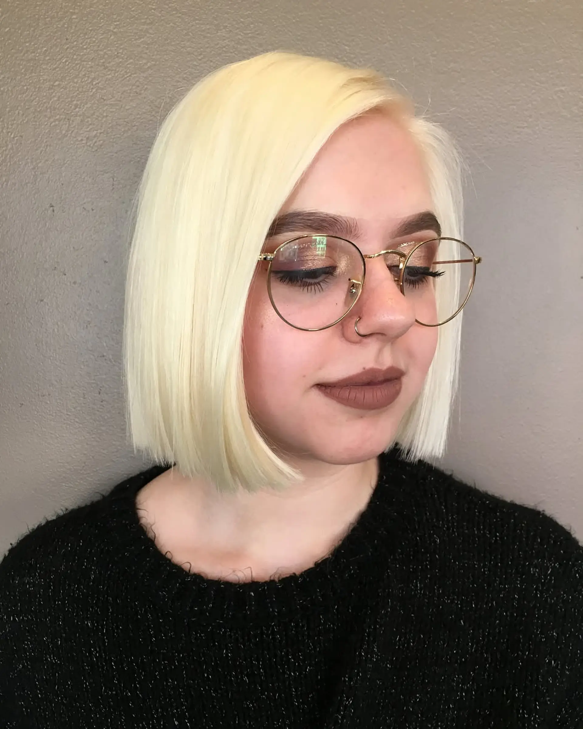 A sleek, chin-length blunt bob styled bone-straight in a pale platinum blonde hue. 1