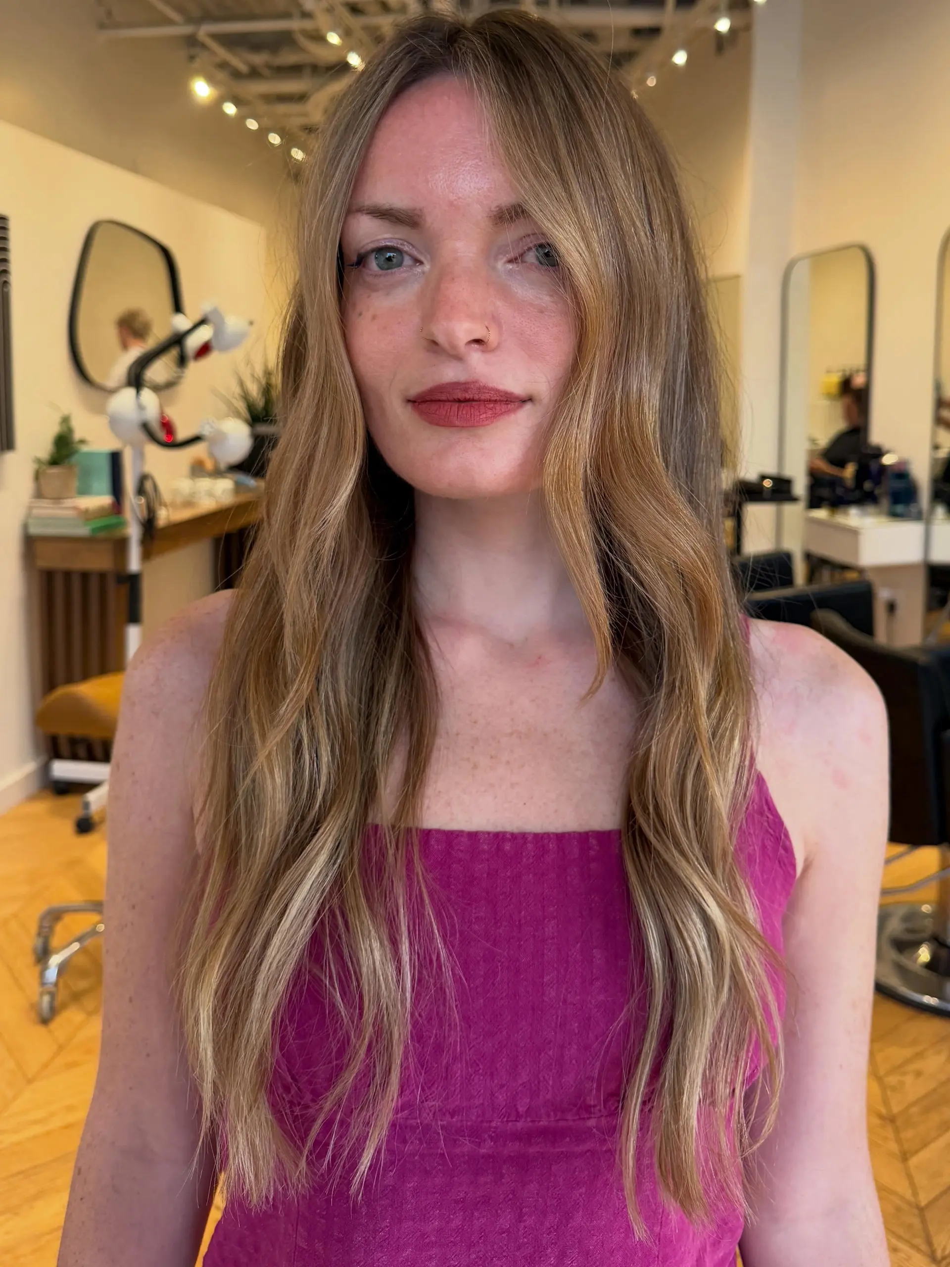 Long golden blonde hair styled in soft, subtle waves with face-framing layers and a center part. 1