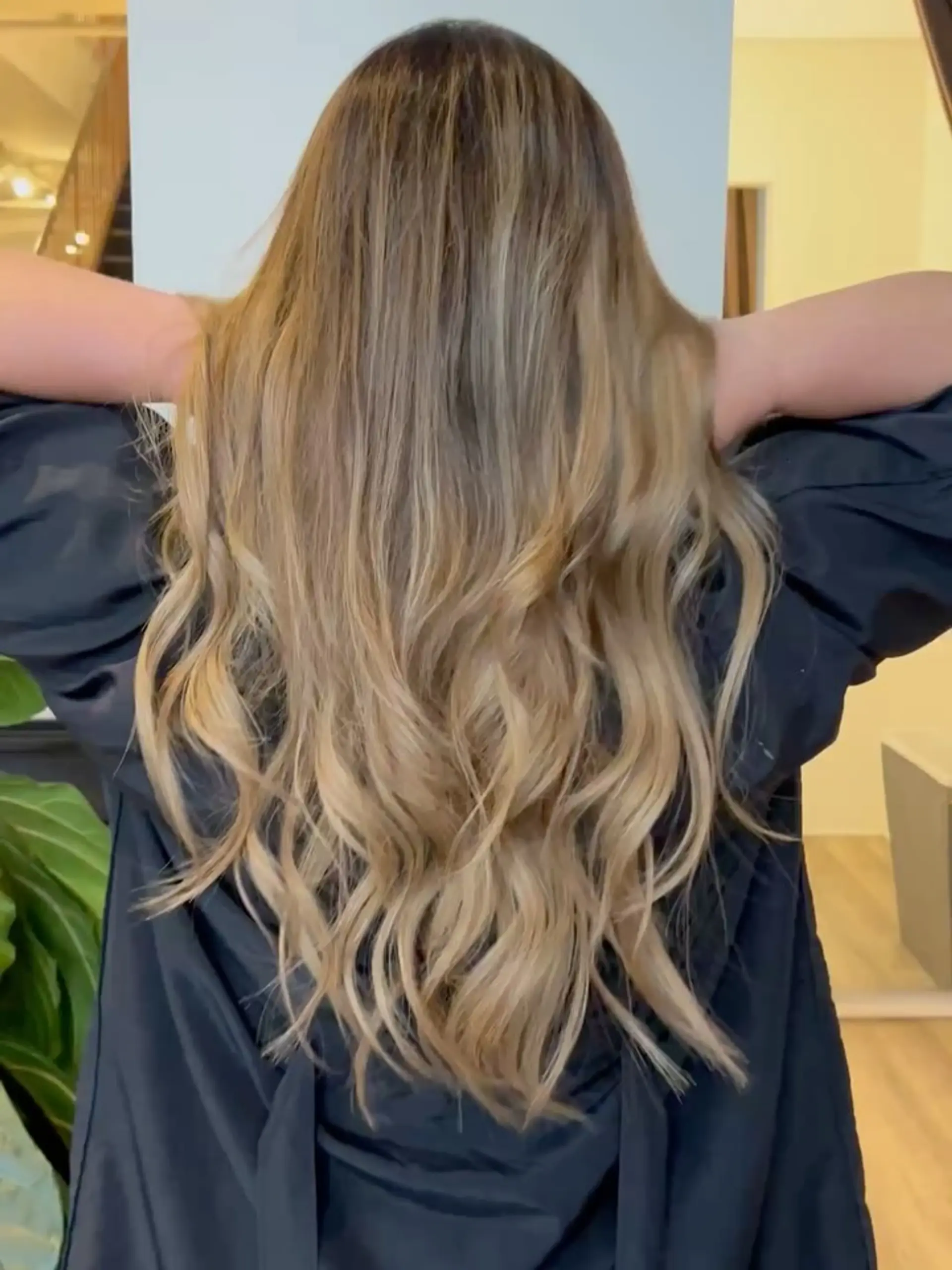 Long, flowing honey blonde hair styled in soft, loose waves cascading down the back. 1