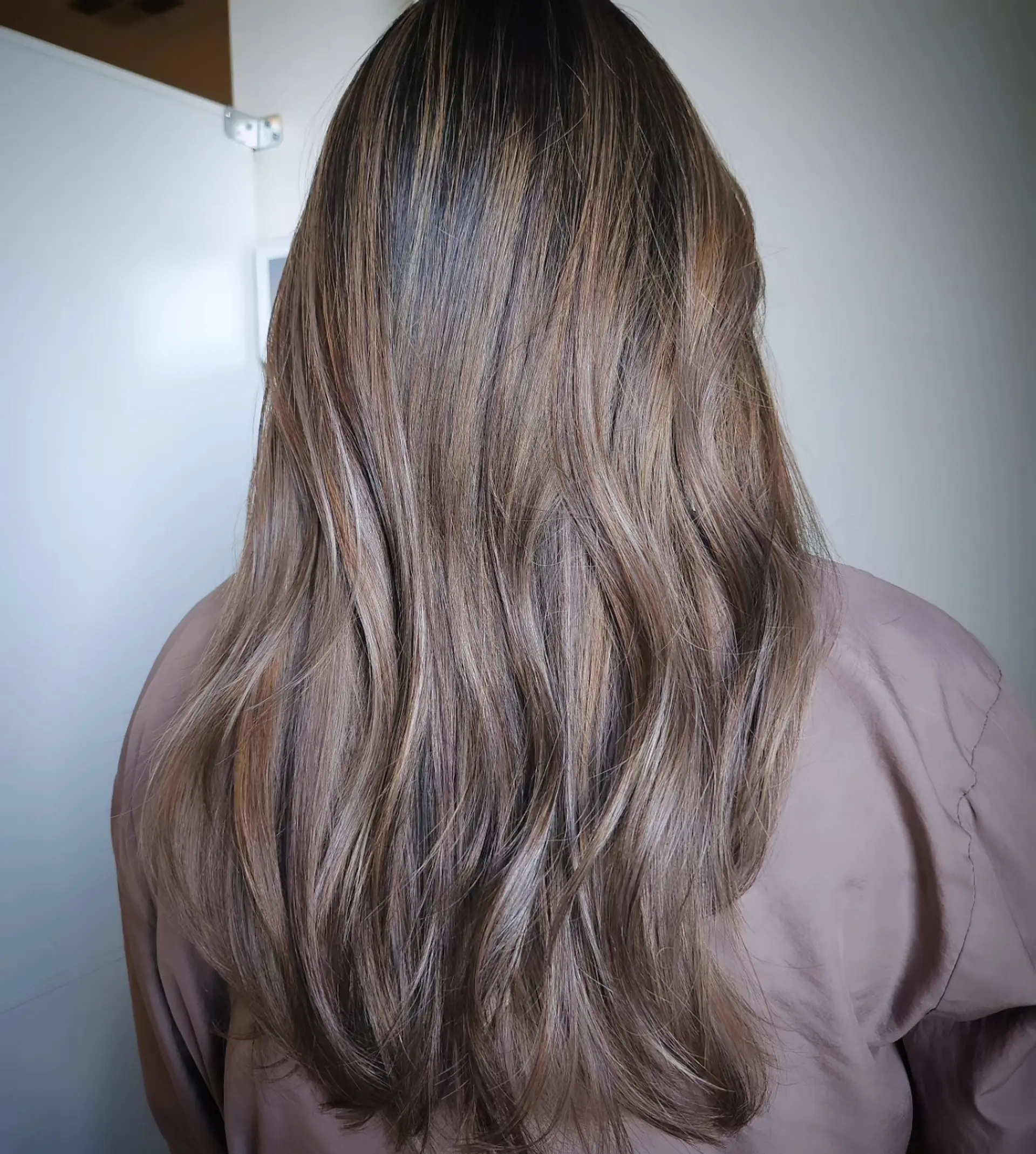 Long layered hair featuring soft, seamlessly blended natural balayage highlights in cool ash brown tones. 1