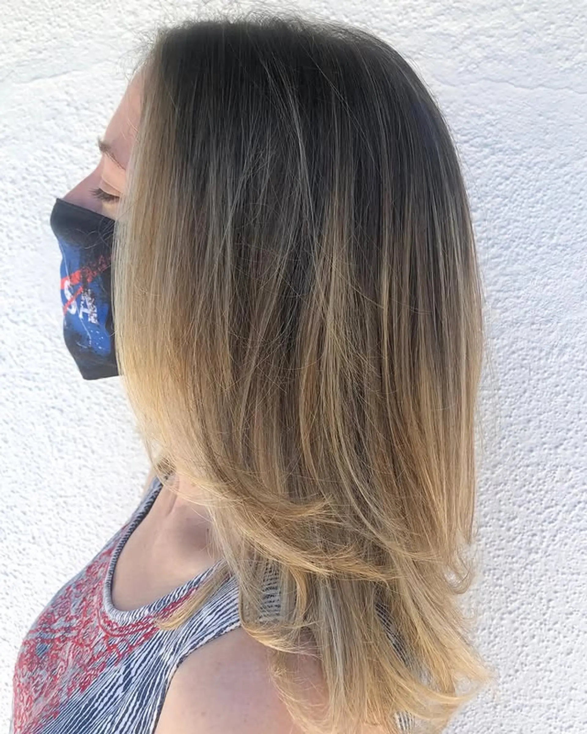 Medium length layered haircut with subtle face-framing layers and a 'bronde' balayage. 1