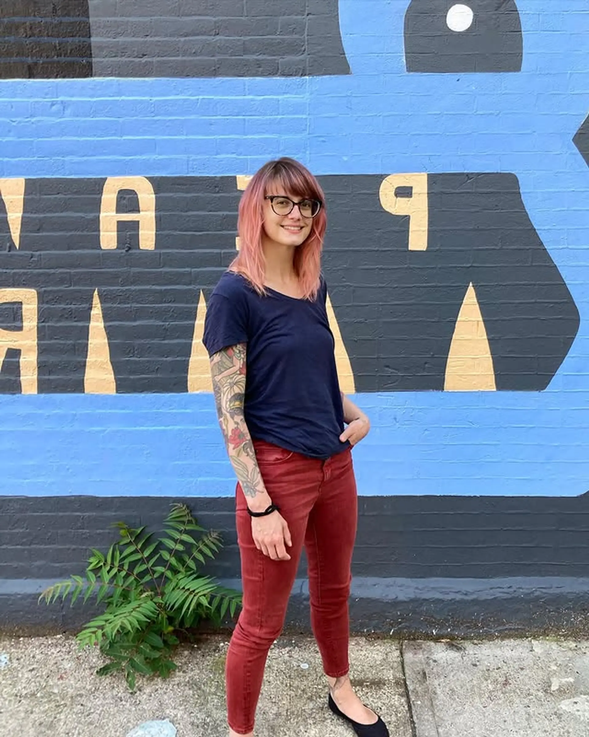 A stylish shag haircut with blunt bangs and a pastel pink tint. 1