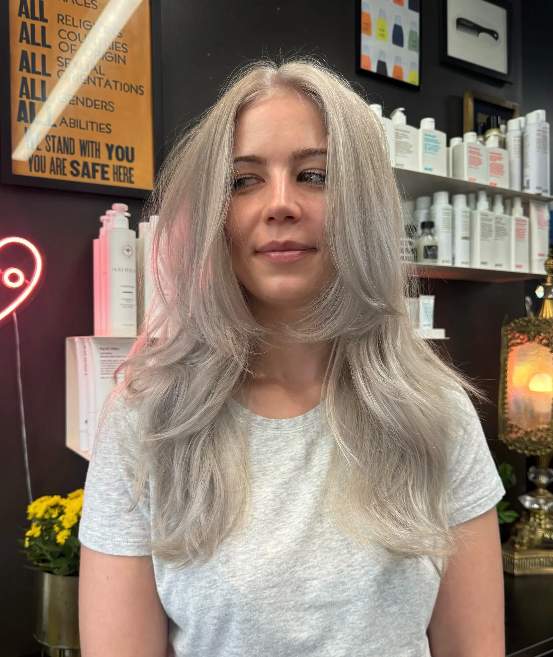 Long icy platinum silver hair with bouncy, face-framing layers and softly curved ends. 1