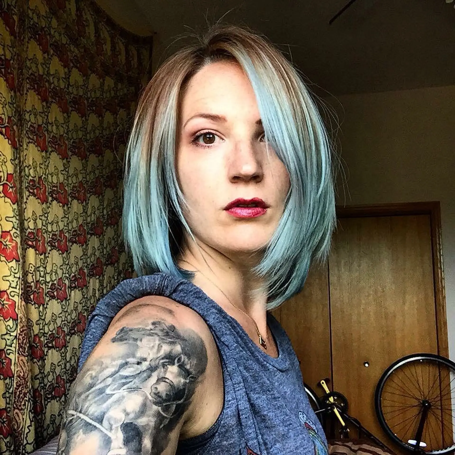 A textured collarbone-skimming bob featuring a soft sky blue ombré balayage blending from natural light brown roots. 1