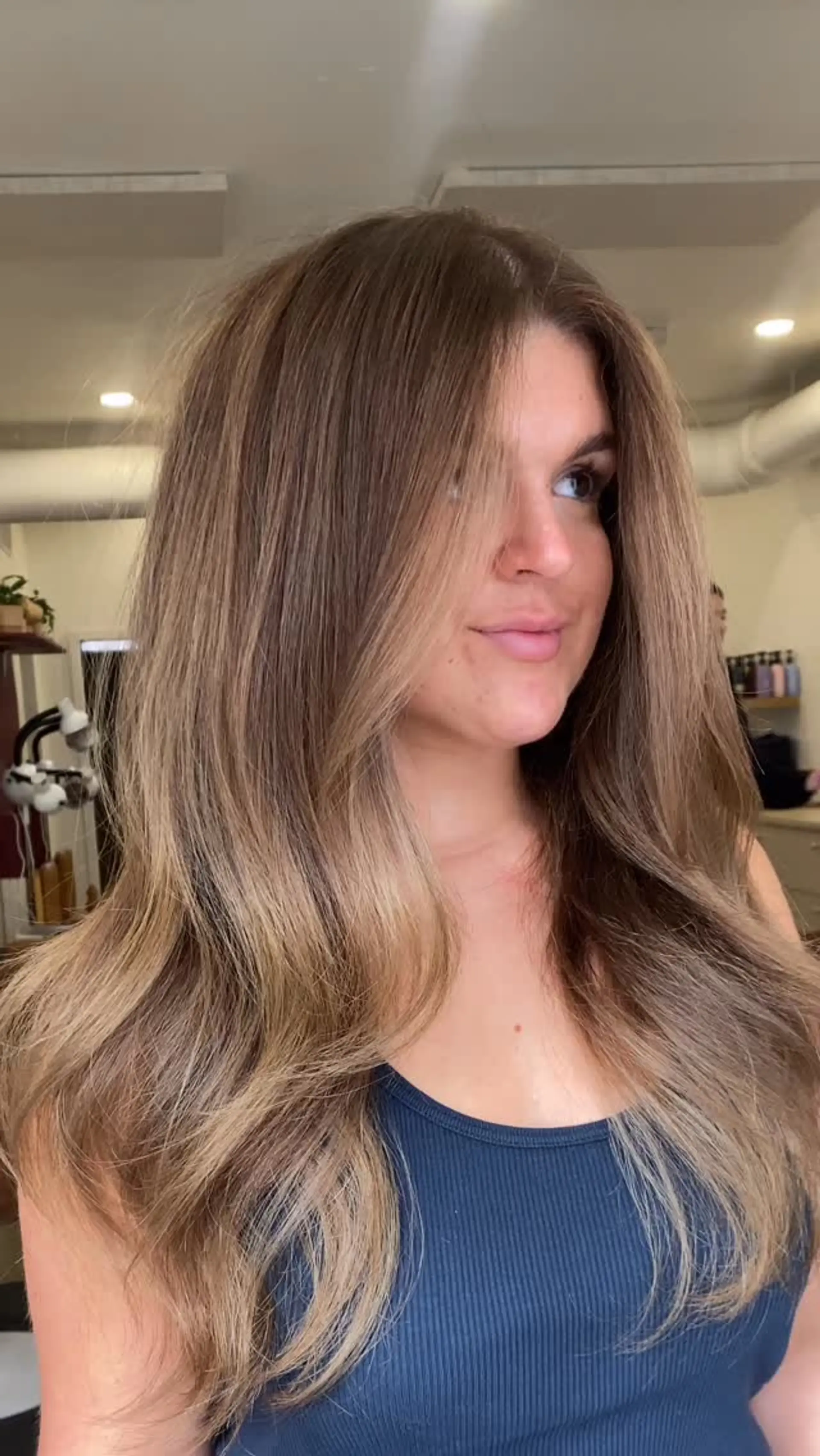 Long bronde hair featuring soft balayage highlights styled in a voluminous blowout with face-framing layers. 1