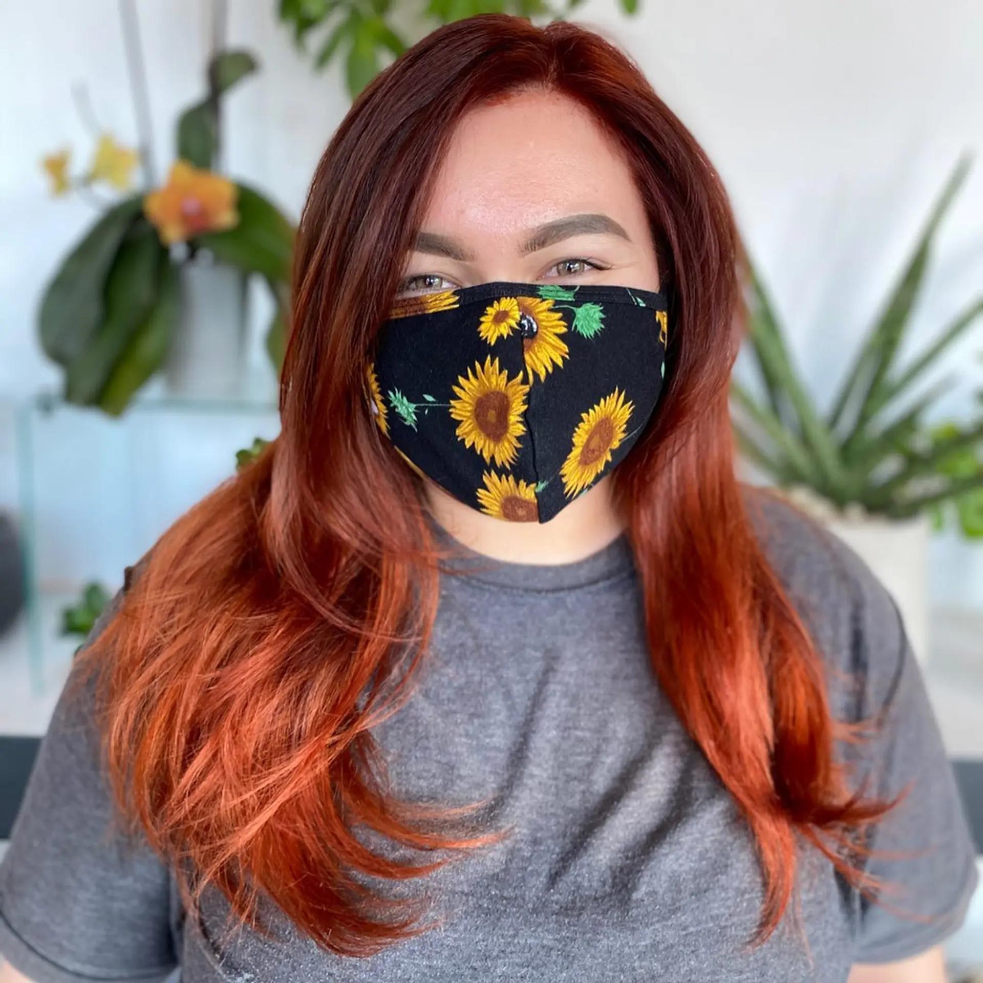 A vibrant auburn to fiery copper color cut with face-framing layers and finished with a smooth blowout. 1