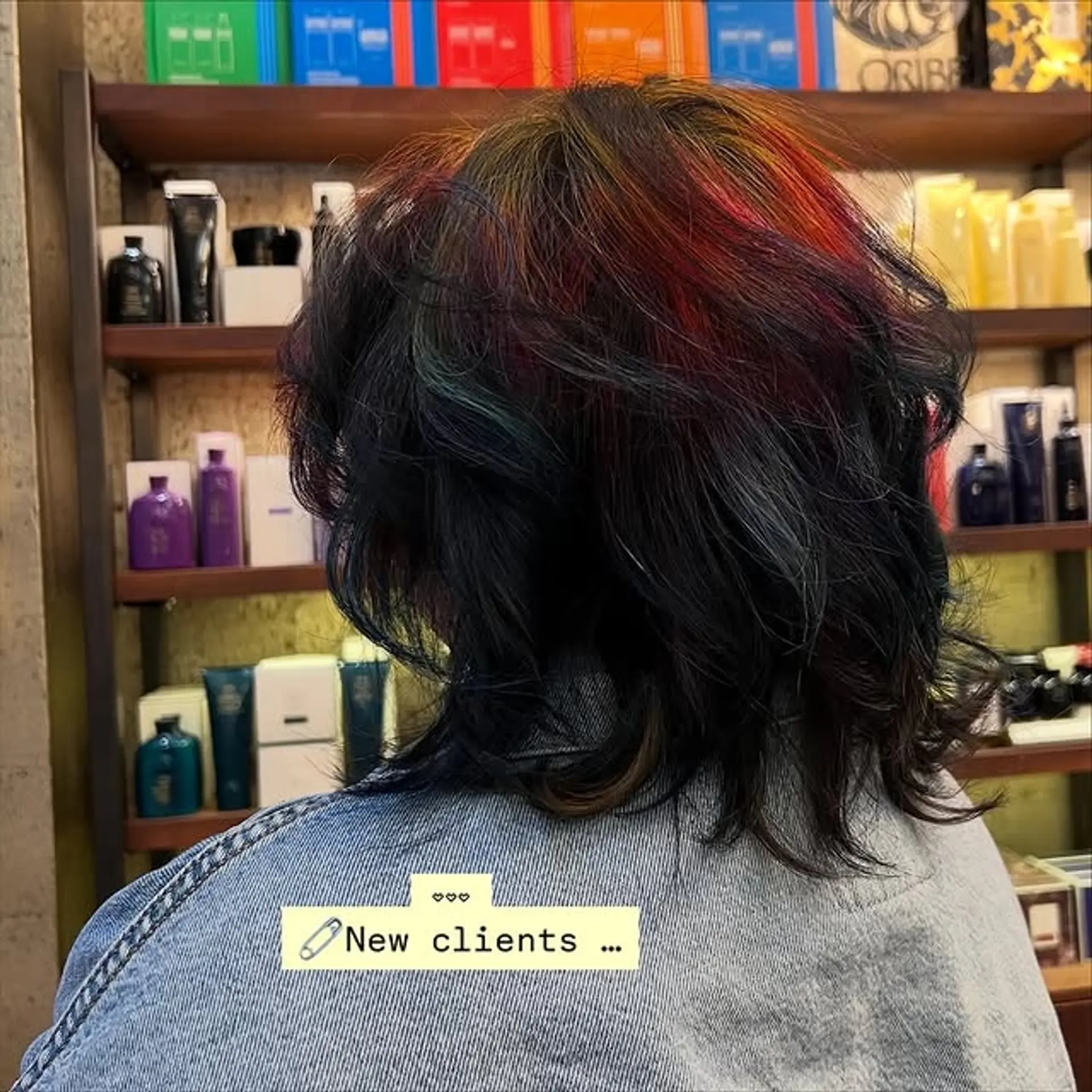 A modern shaggy pixie cut featuring choppy layers and vibrant rainbow highlights. 1