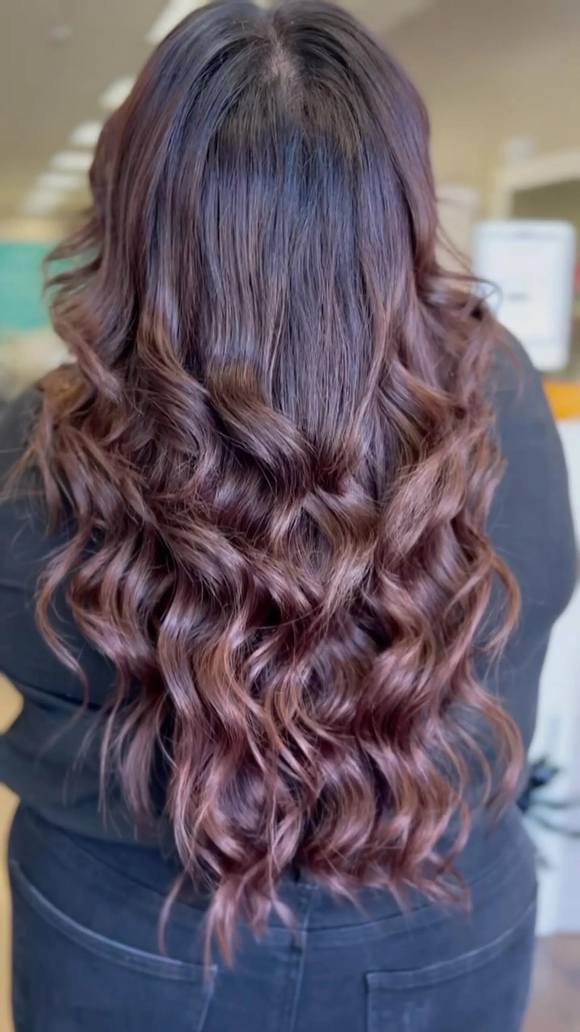 Long chocolate brown hair styled with loose, glossy textured waves throughout the mid-lengths and ends. 1