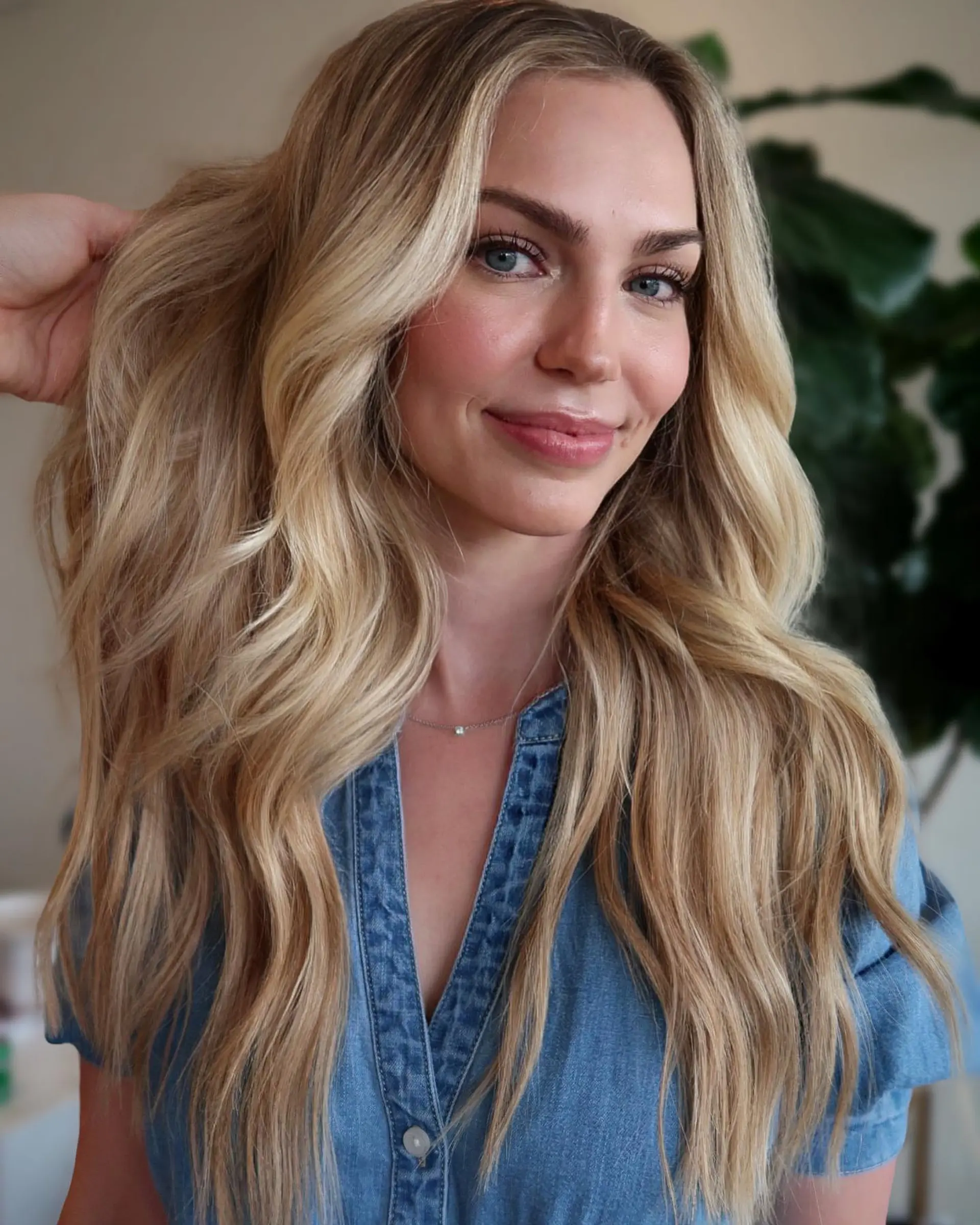 Long, dimensional blonde hair styled into voluminous, loose waves with a soft middle part. 1