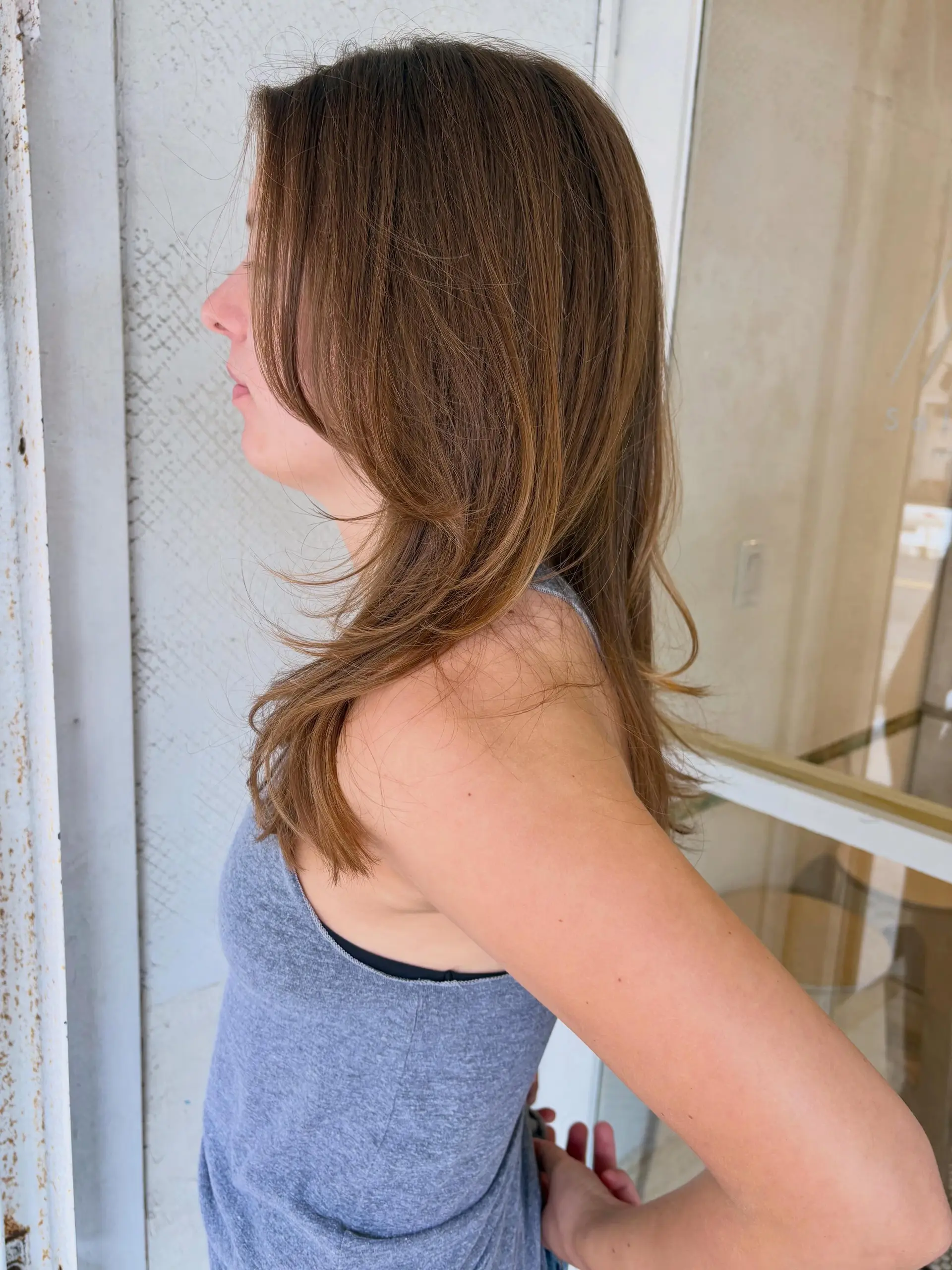 A soft layered cut featuring delicate face-framing curtain layers and feathered ends. 1