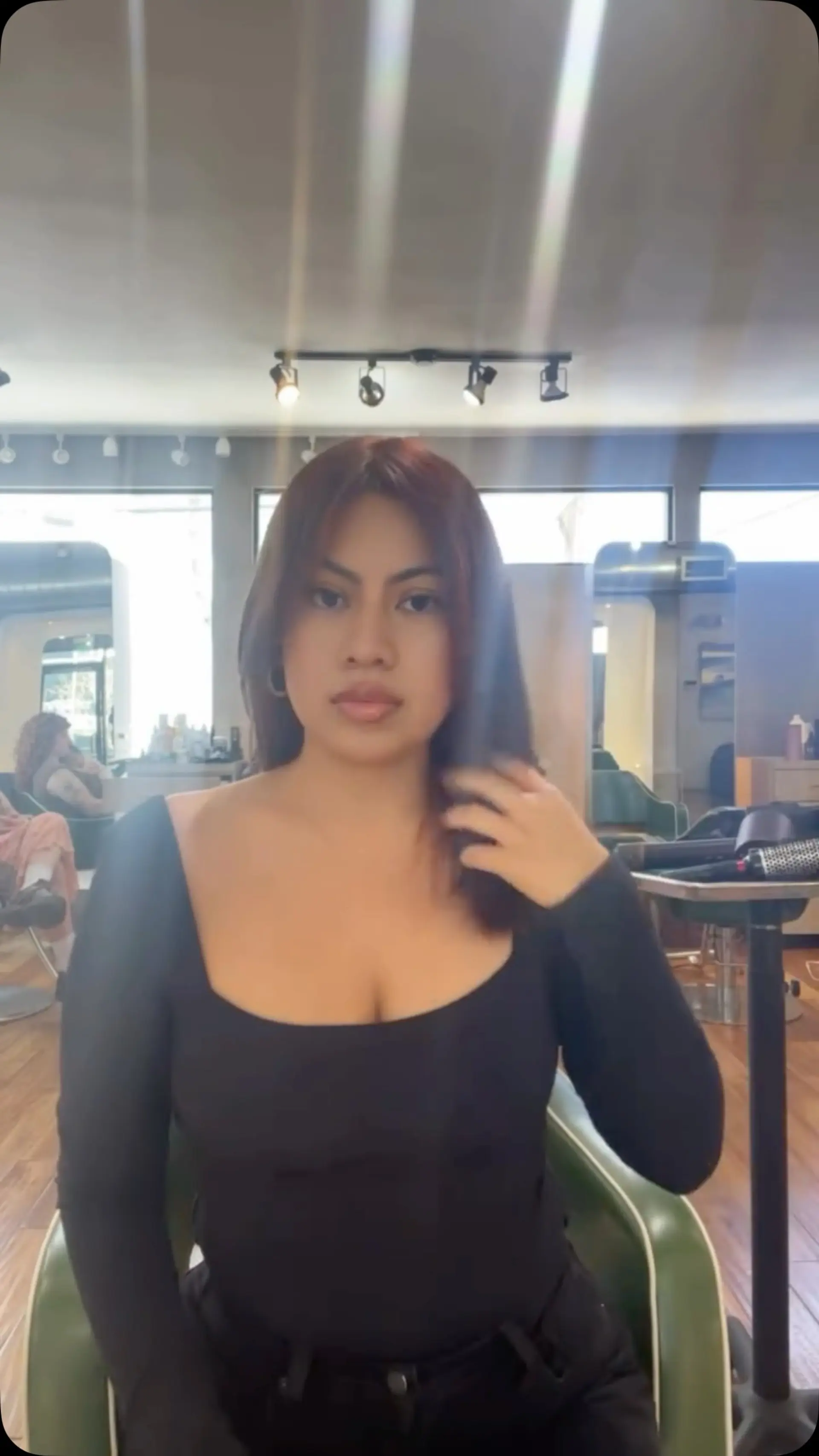 A sleek, smooth blowout in a rich red-copper tone, styled with a center part and soft face-framing layers. 1