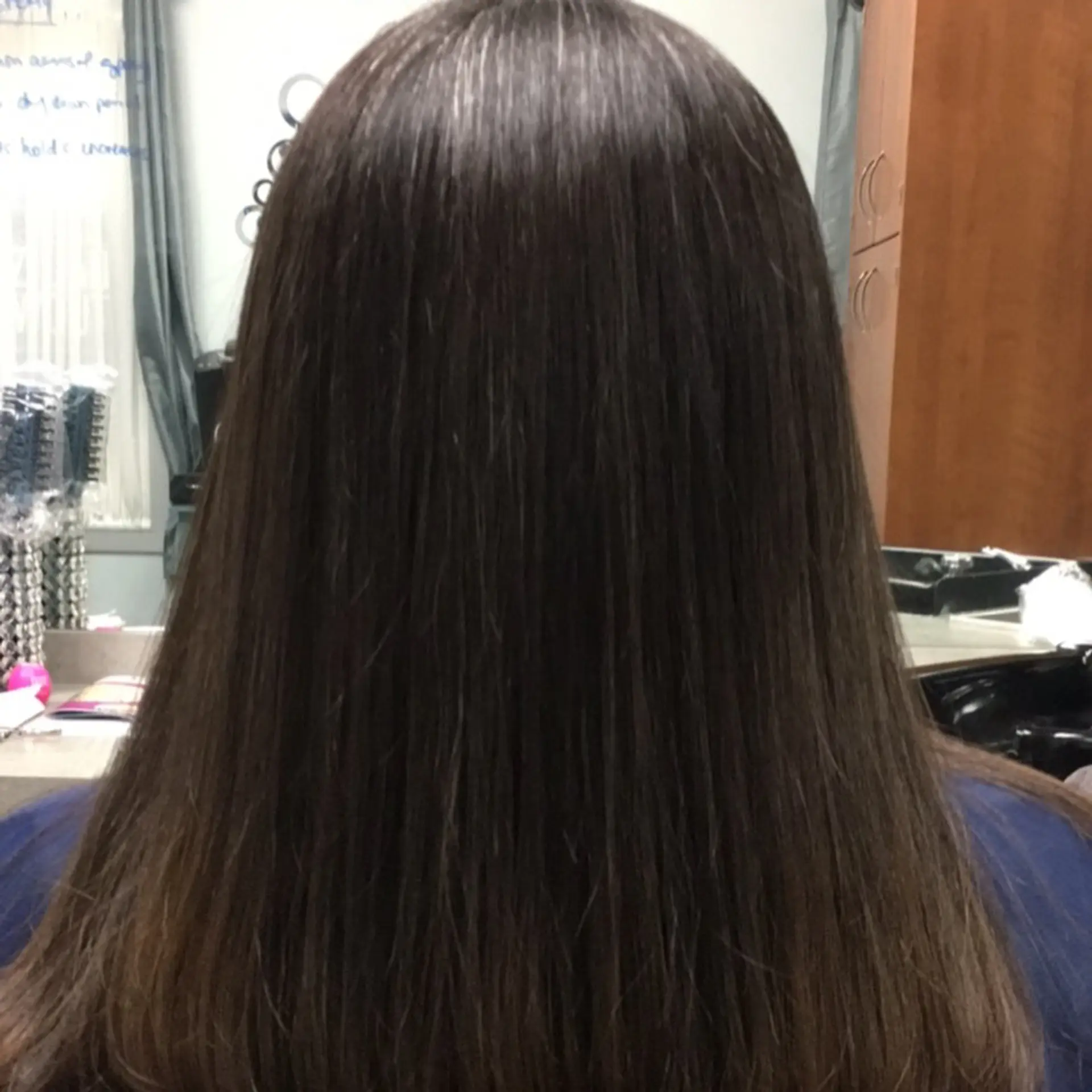 Long, smooth dark brunette hair styled pin-straight with a clean trimmed finish. 1