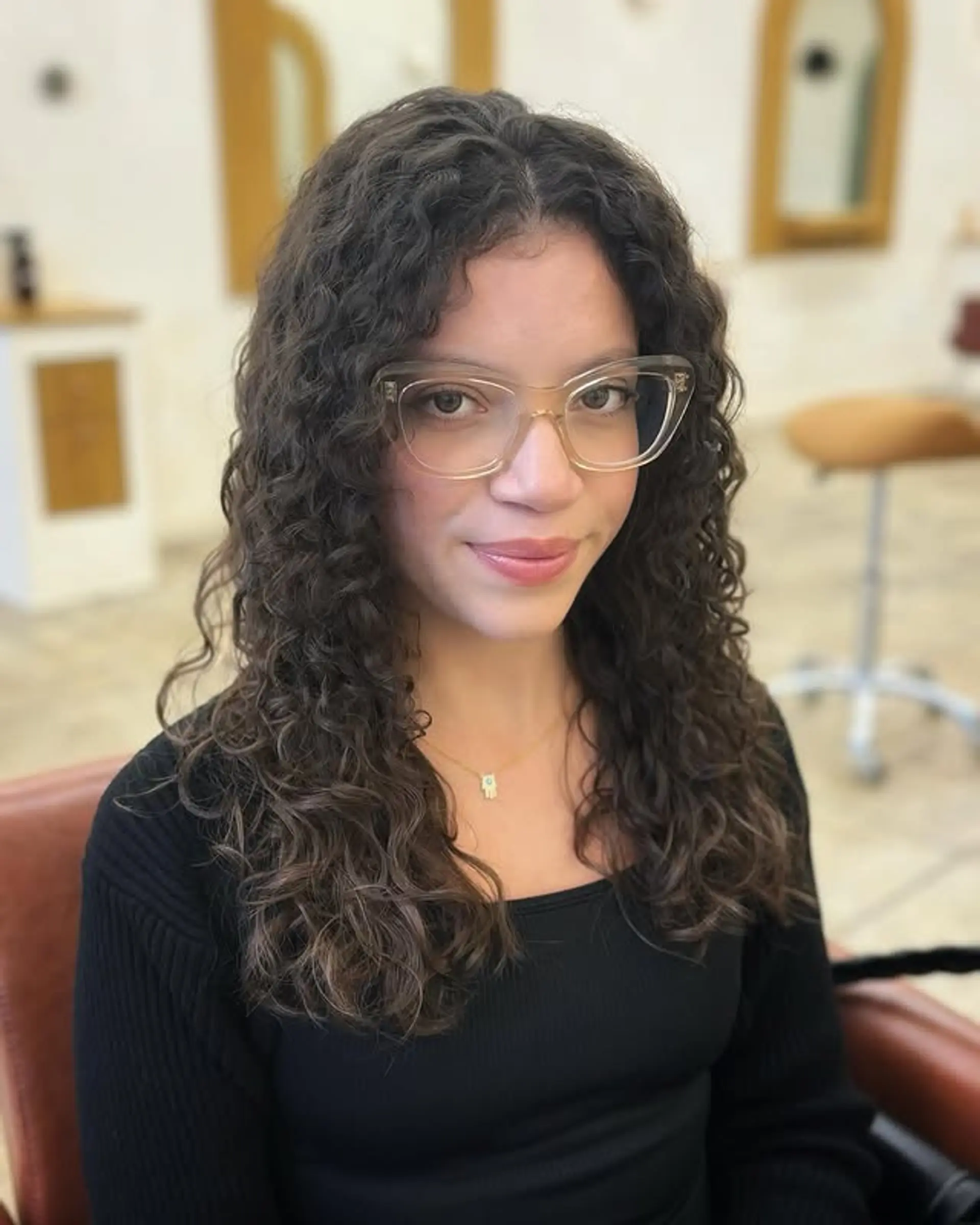 A natural, curly bob with defined curls and a medium length. 1