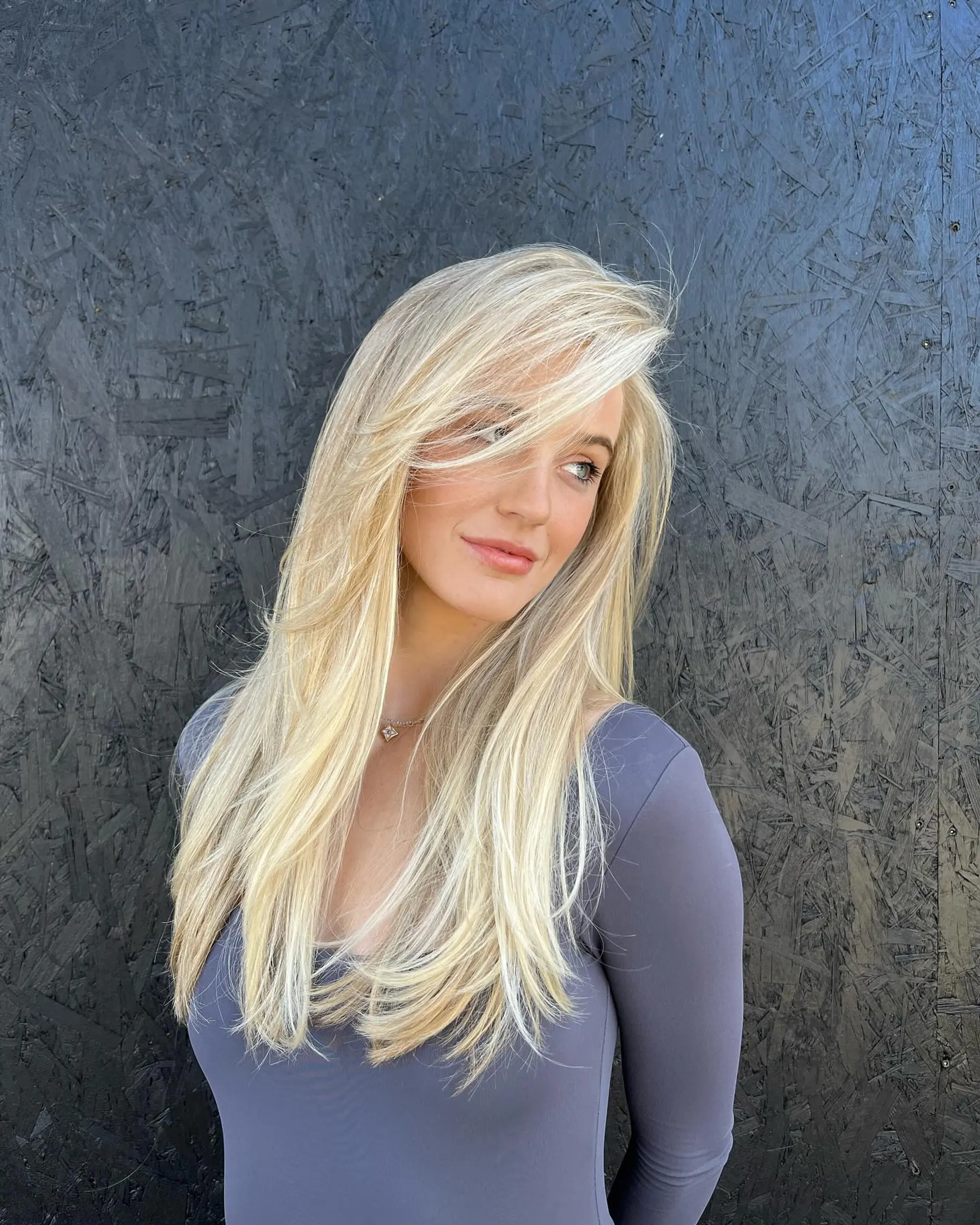 Long, luminous platinum blonde hair styled smooth with layered face-framing and side-swept bangs. 1