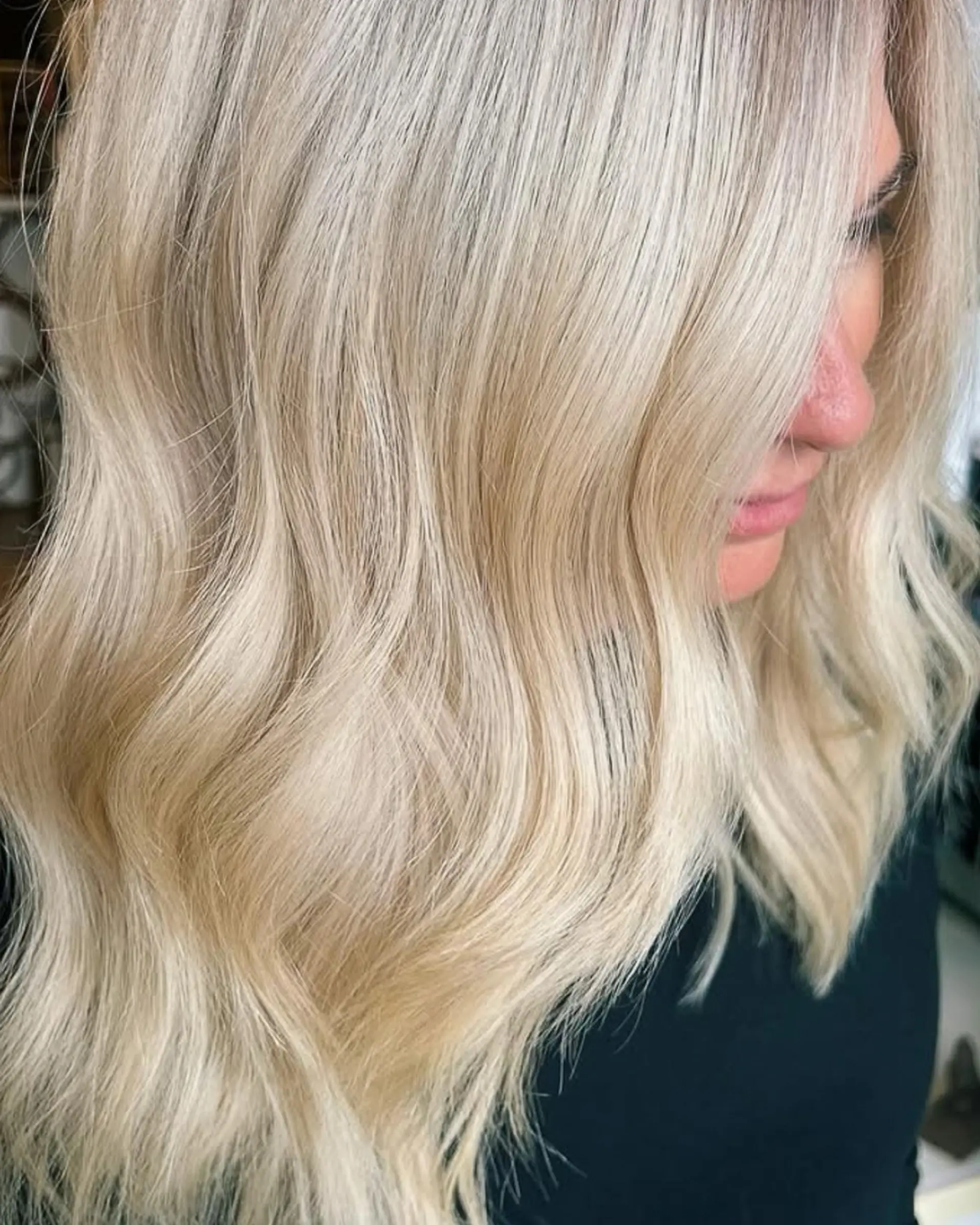 Bright, light blonde hair styled in soft, cascading waves. 1