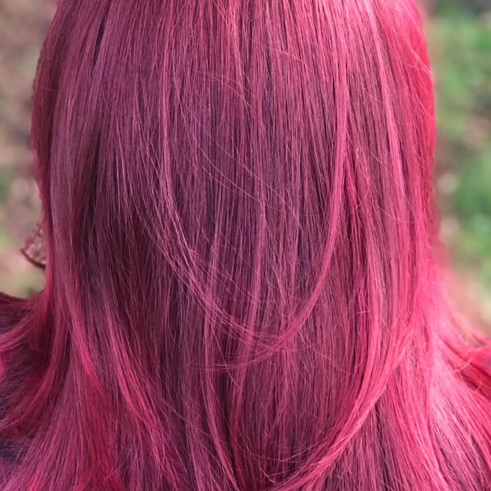 Vibrant raspberry magenta hair with subtle layers and a smooth, straight finish. 1