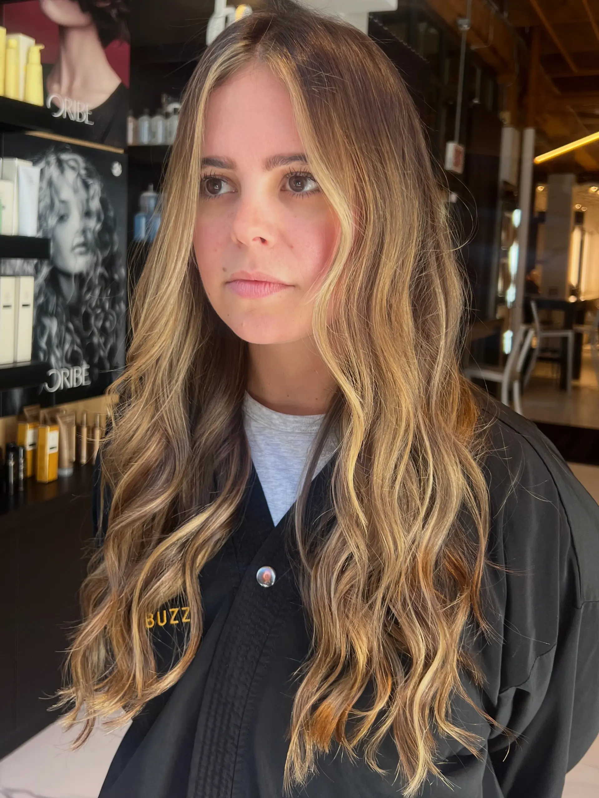 Long cascading bronde hair featuring bright face-framing blonde pieces and soft, relaxed waves. 1