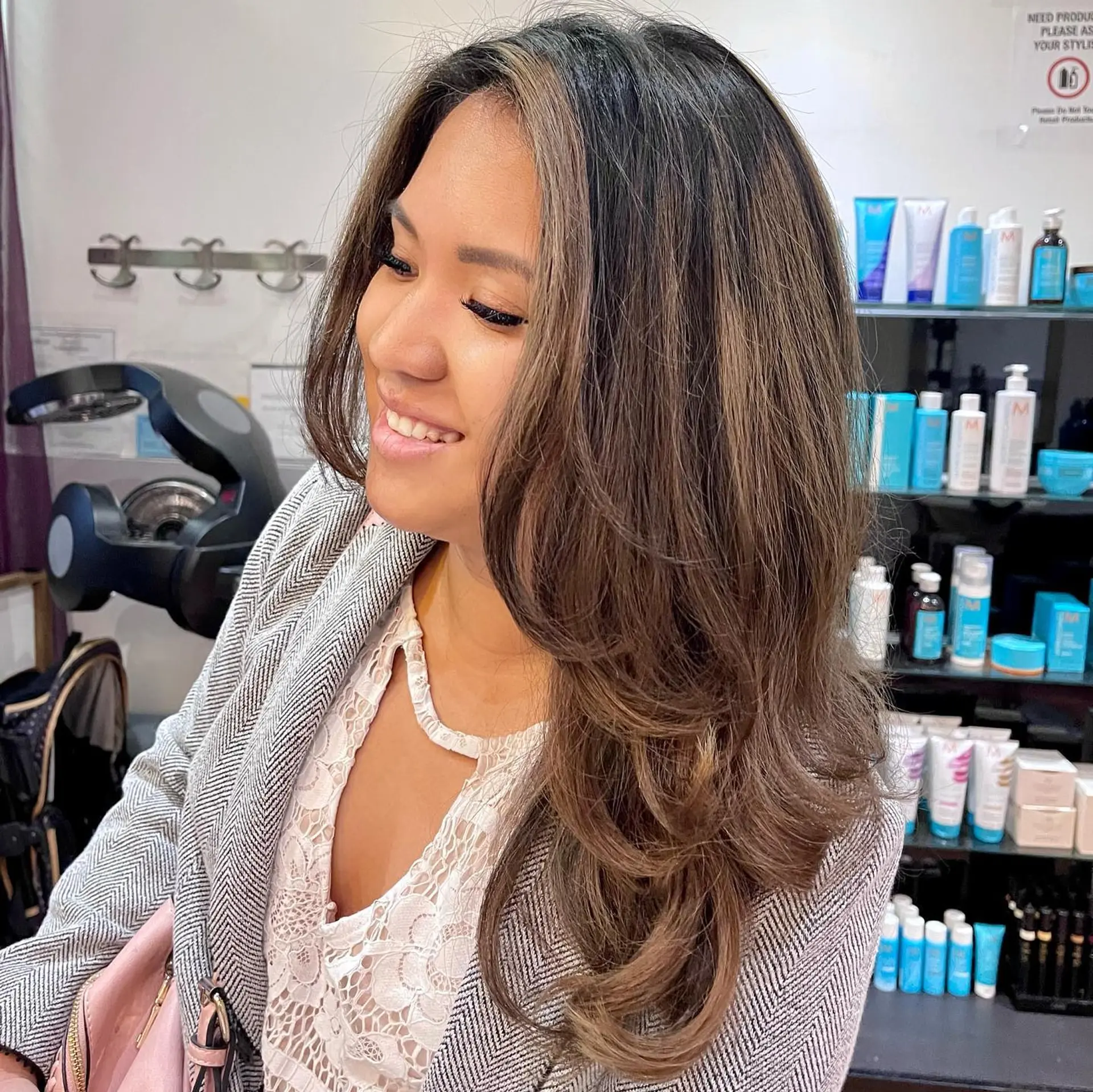 Long layered brunette hair with subtle dimensional tones, styled into a smooth, voluminous blowout with soft face-framing curves. 1